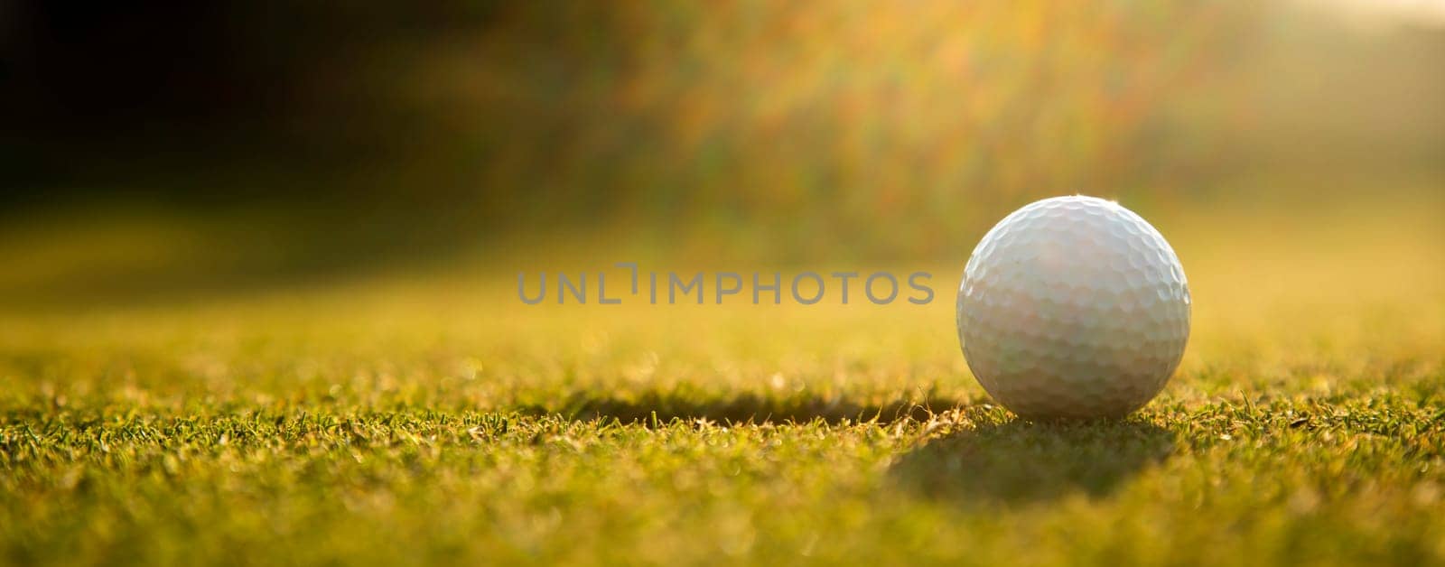 Golf ball, course on a sunny day