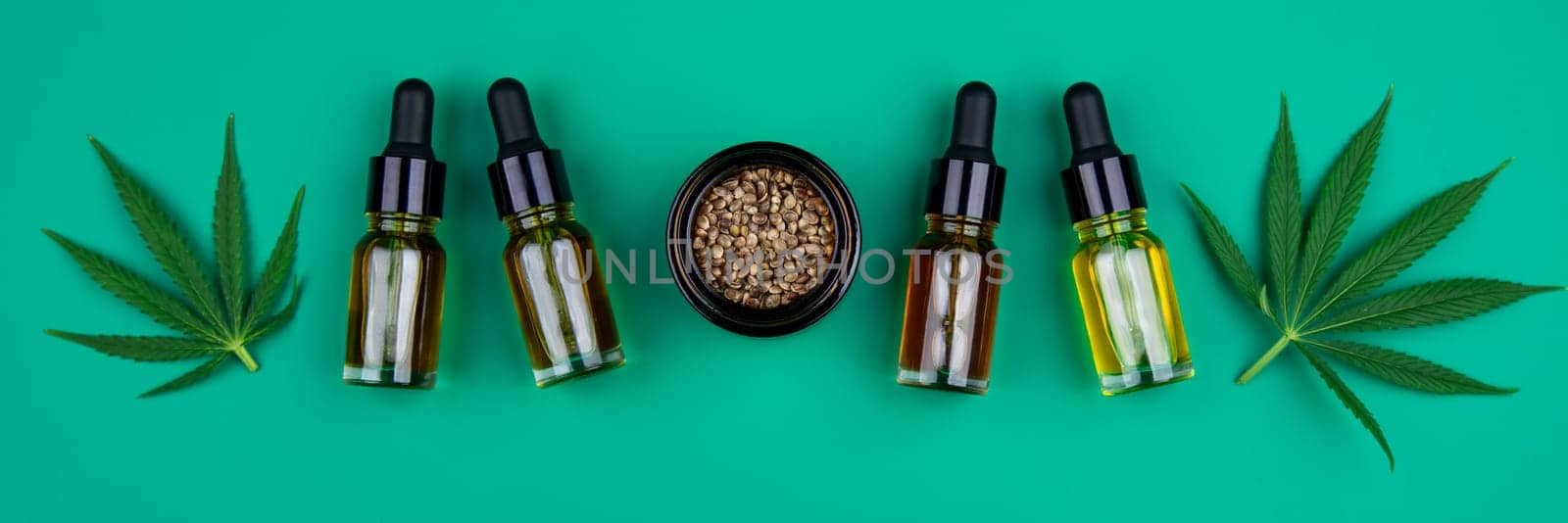 Flat lay composition with marijuana leaves, bottle of oil, marijuana and cannabis on cbd