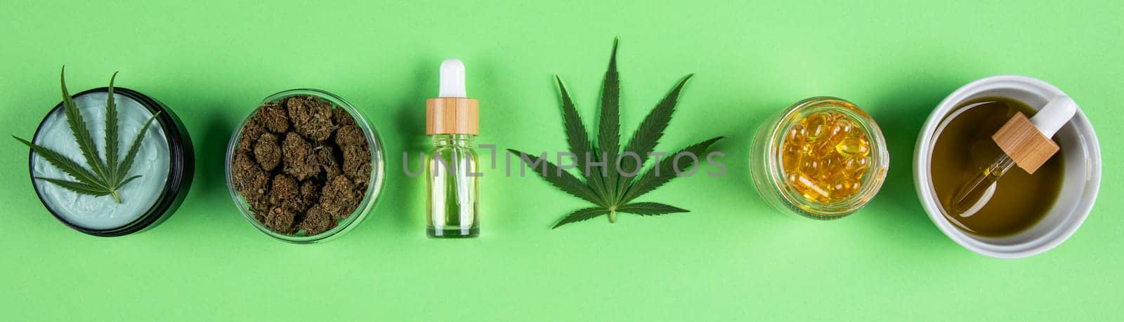 Composition with marijuana leaves, bottle of oil, cannabis on cbd