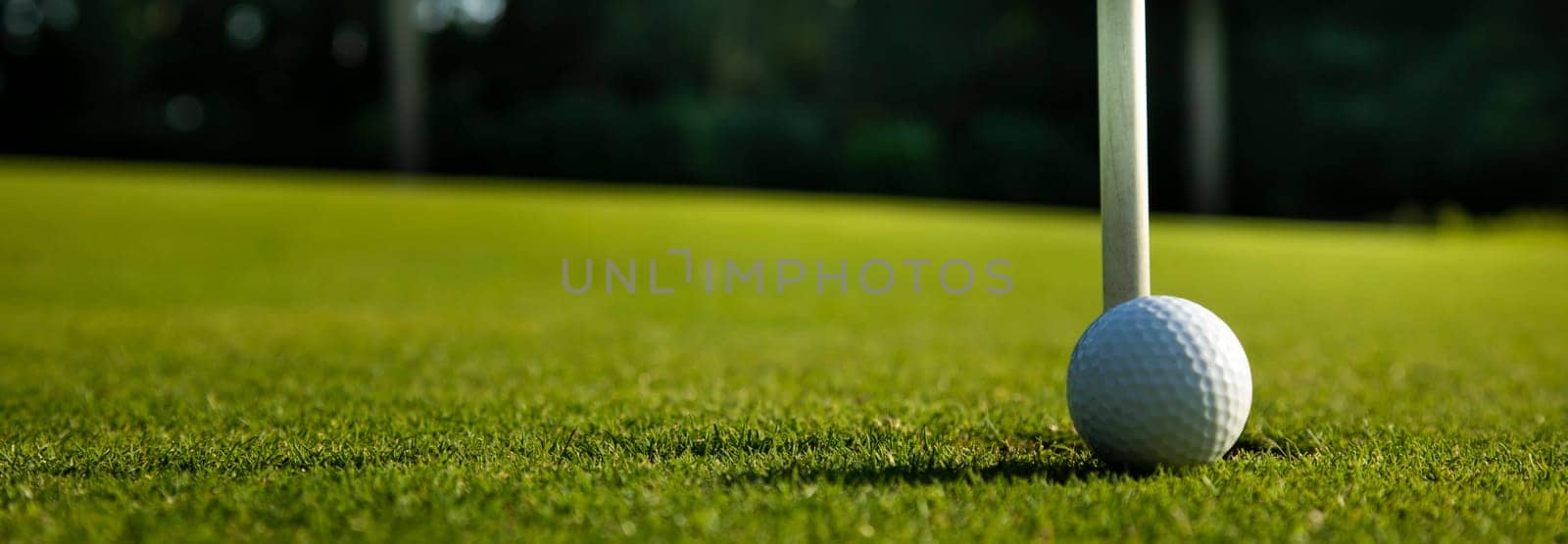 Golf ball and clubs in golf field