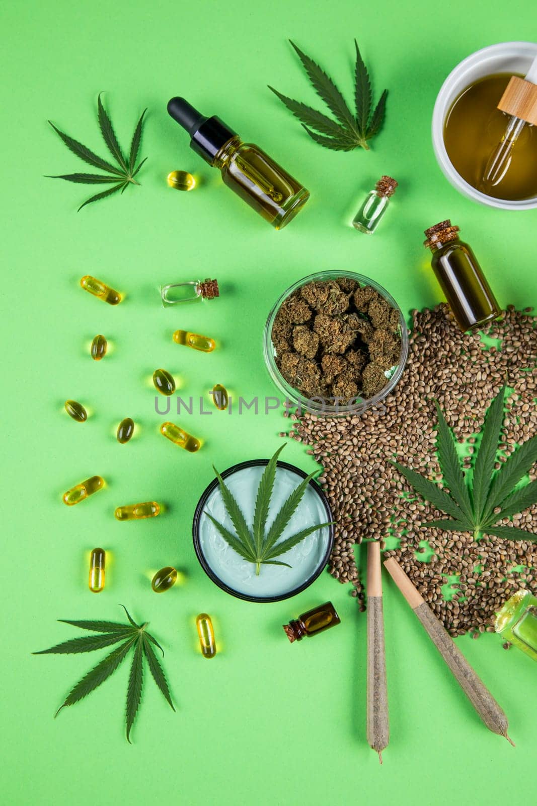 Composition with marijuana leaves, bottle of oil, cannabis on cbd