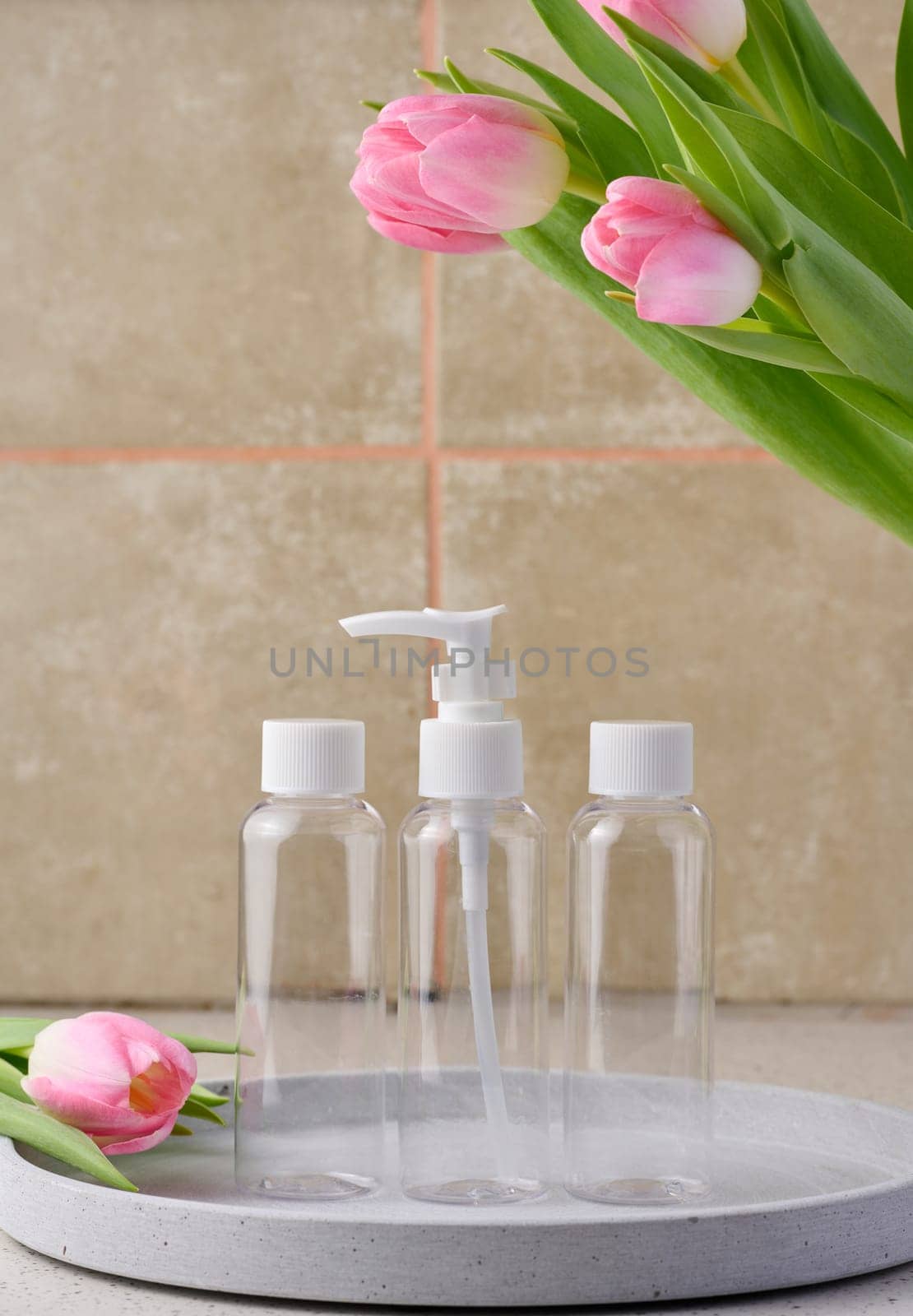 Transparent plastic container with a dispenser on the table. Bottle for liquid soap, shampoo