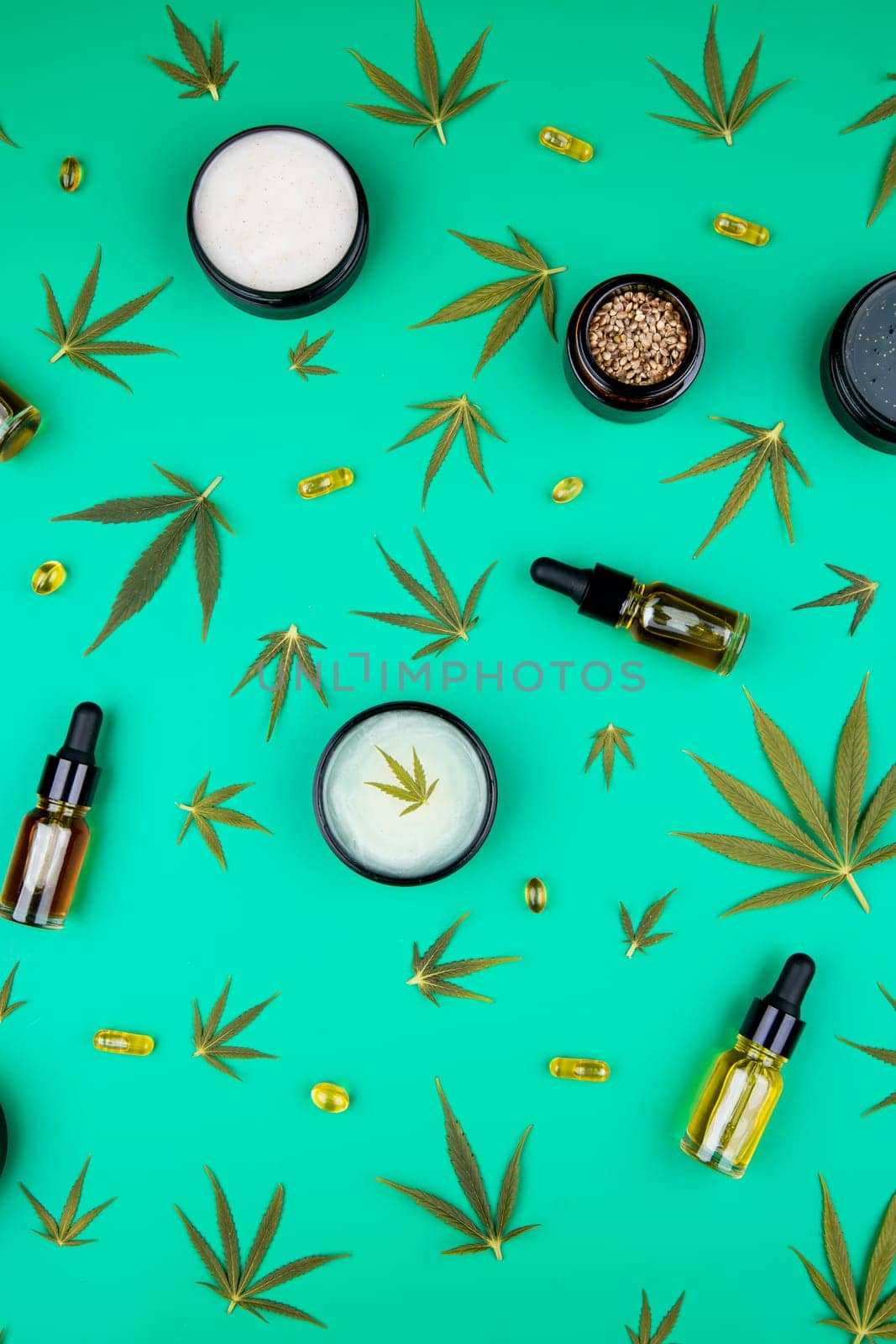 Flat lay composition of marijuana and hemp seeds on color green background