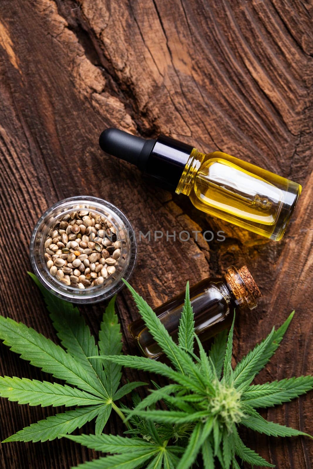 Cannabis oil bottle and marijuana leaves