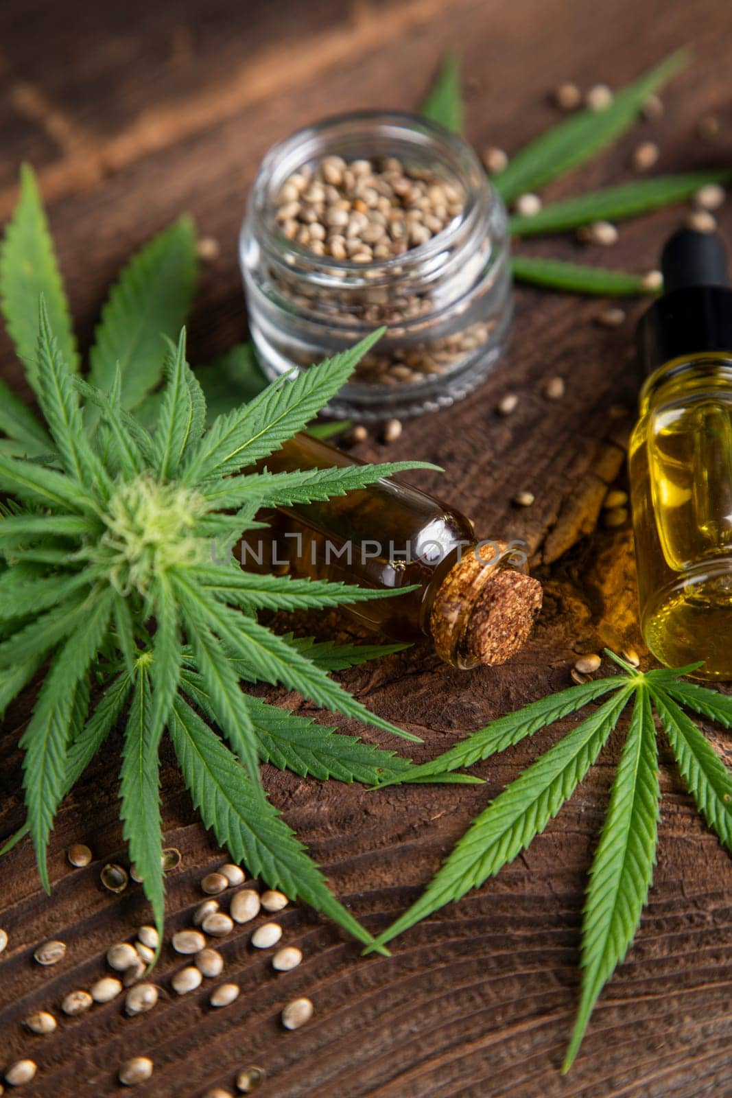 Cannabis oil bottle and marijuana leaves