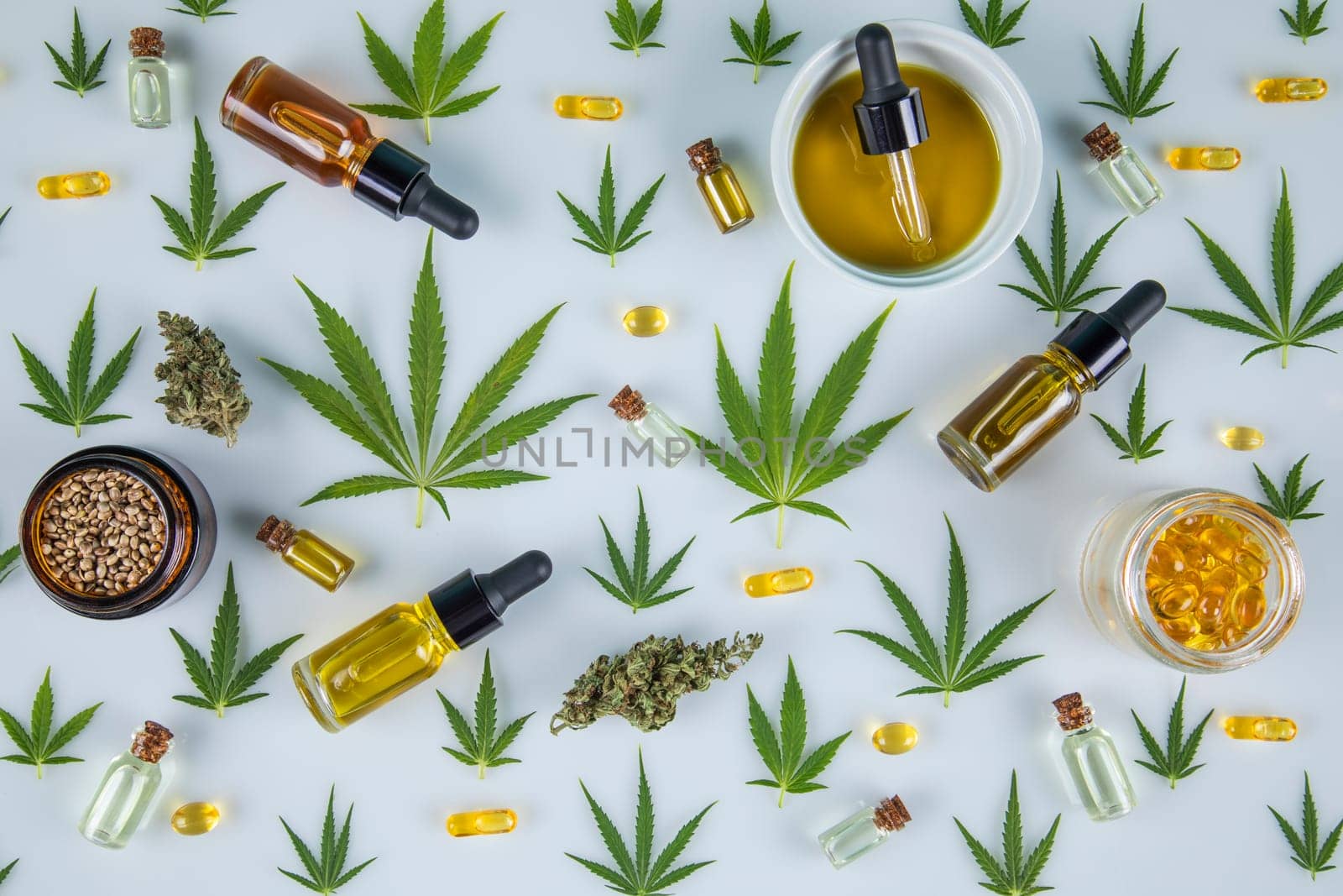 Top view of marijuana leaves and cannabis buds on white background