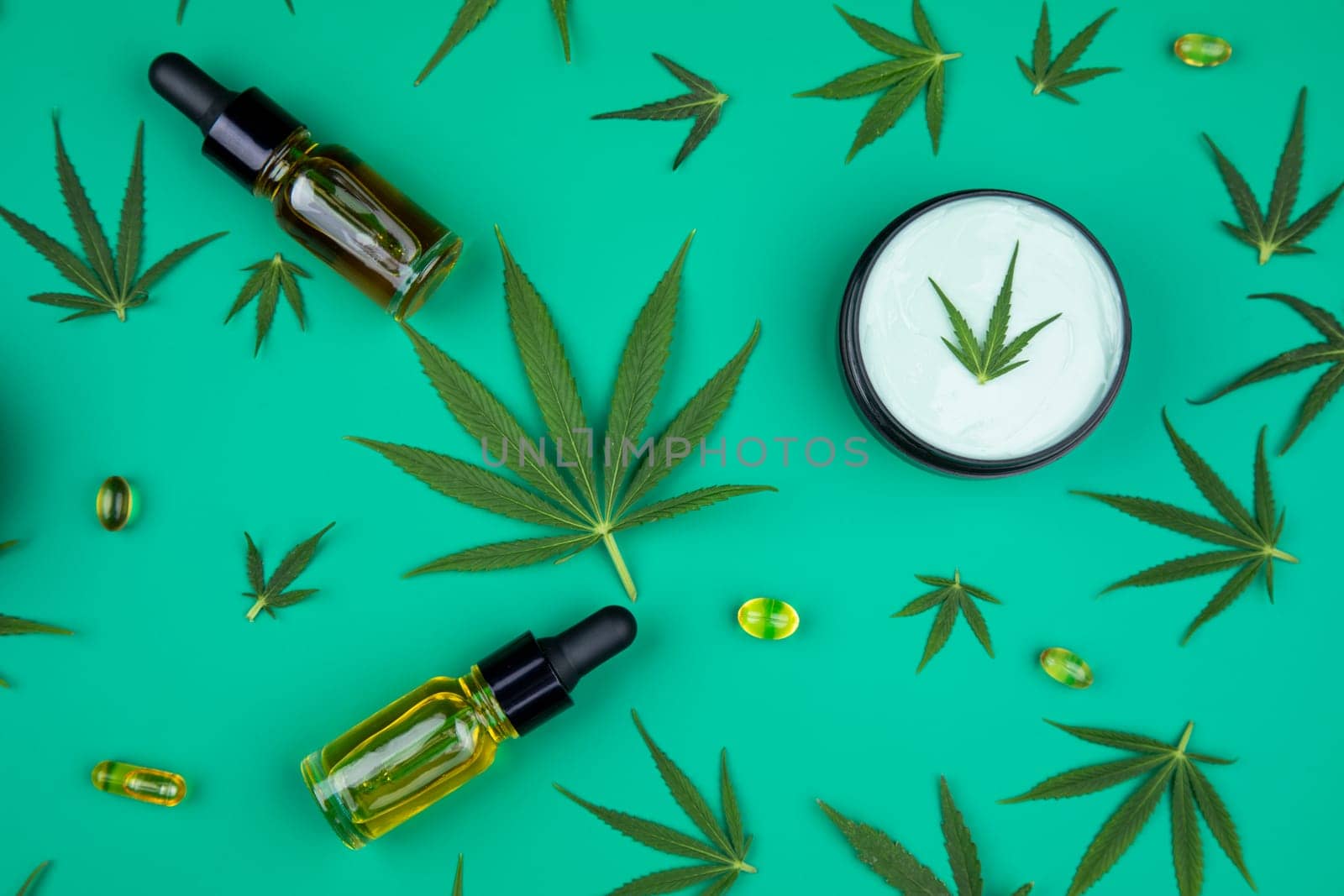 Flat lay composition with marijuana leaves, bottle of oil, marijuana and cannabis on cbd