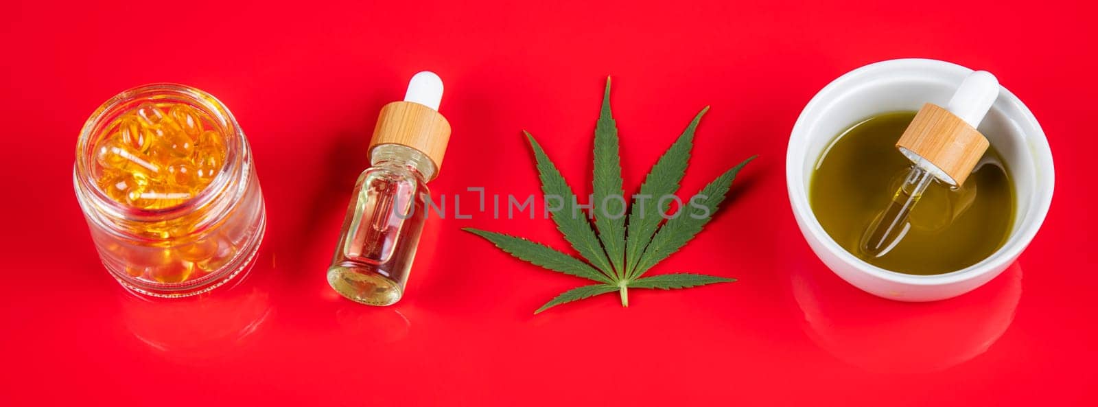 Composition with marijuana leaves, bottle of oil, cannabis on cbd