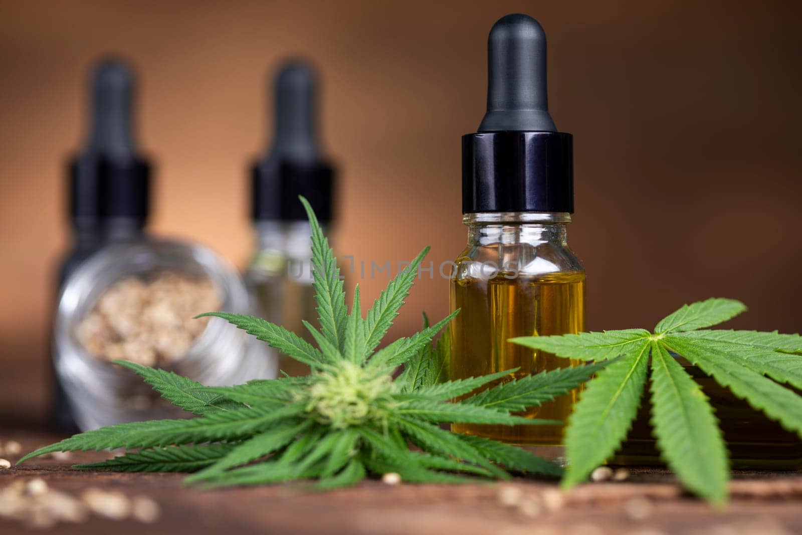 Cannabis oil bottle and marijuana leaves