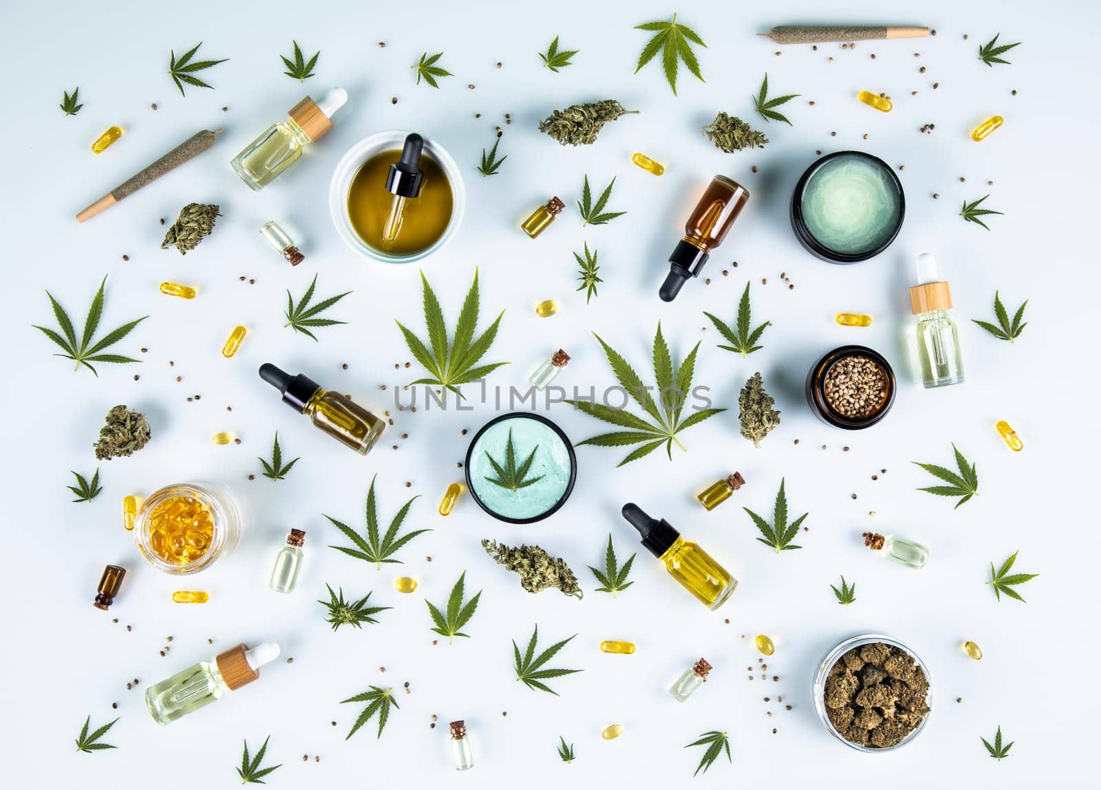 Flat lay composition with marijuana leaves, bottle of oil, cannabis on cbd, white background