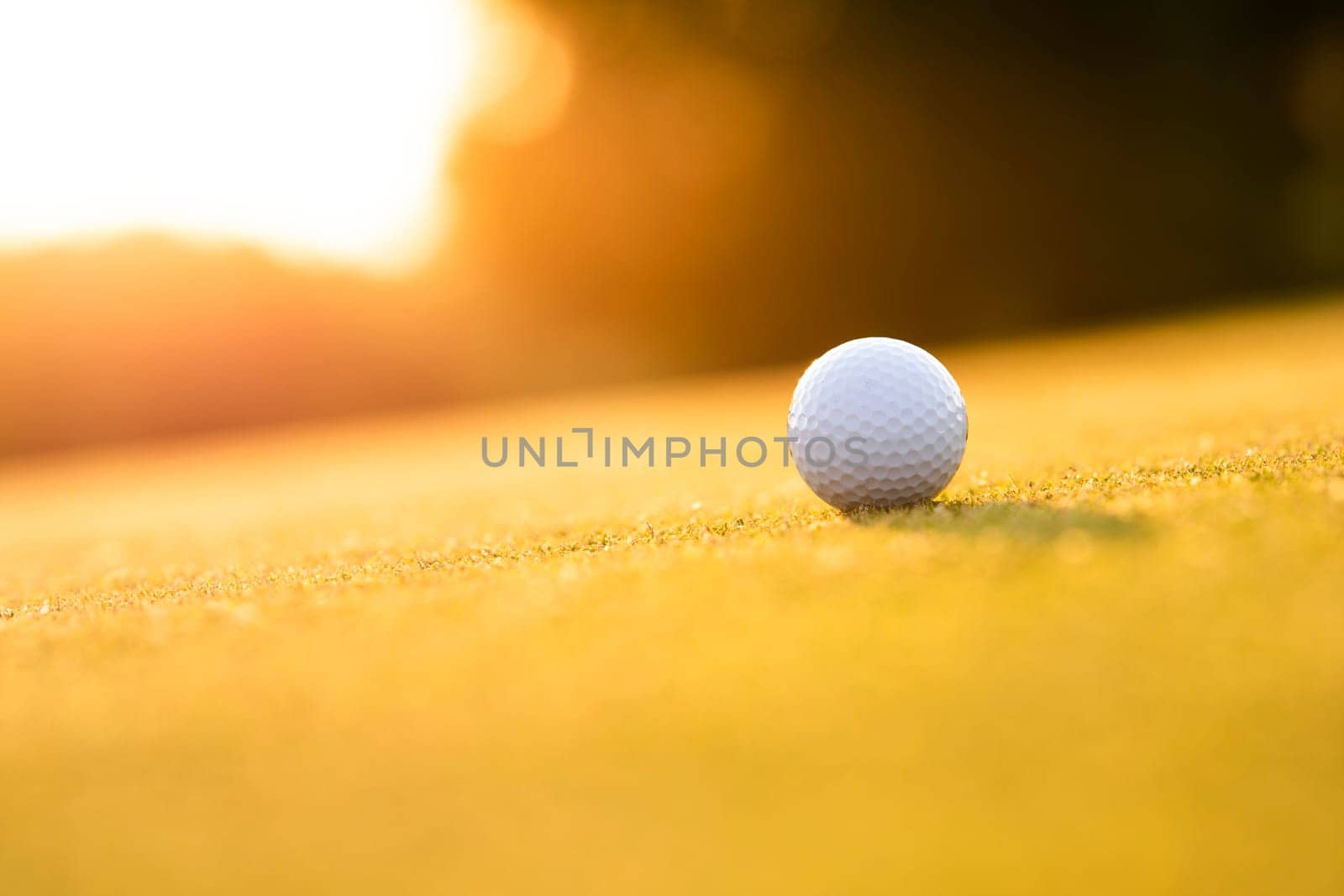 Golf ball and clubs in golf field