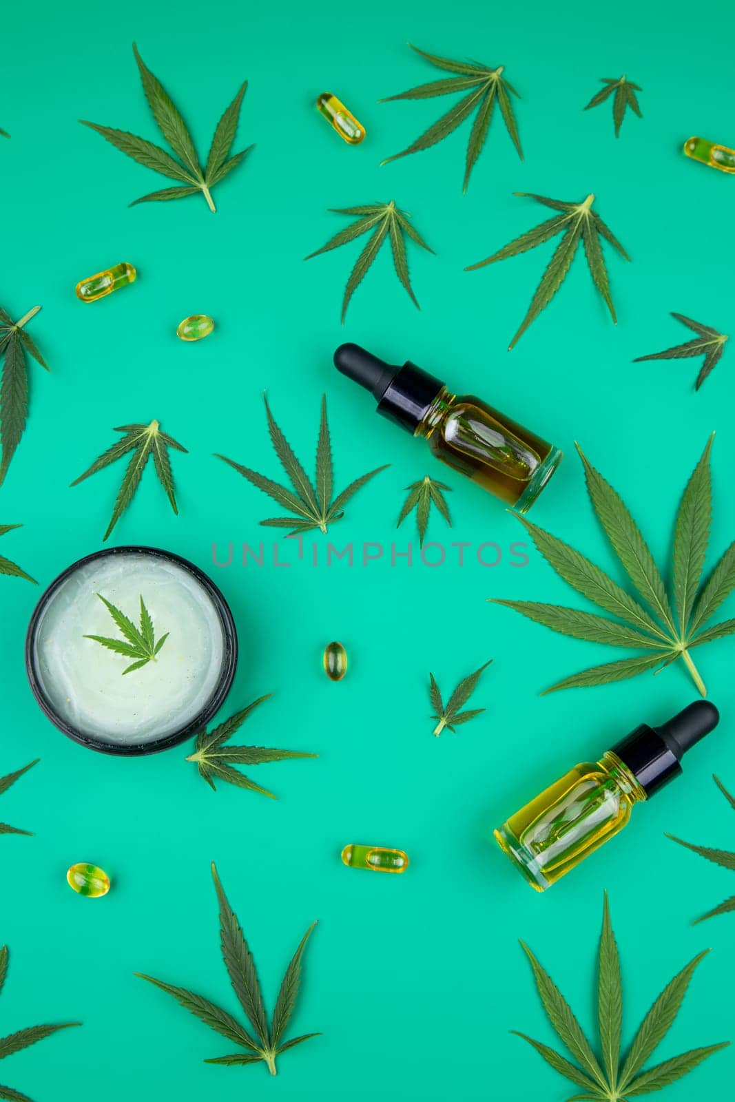 Flat lay composition of marijuana and hemp seeds on color green background