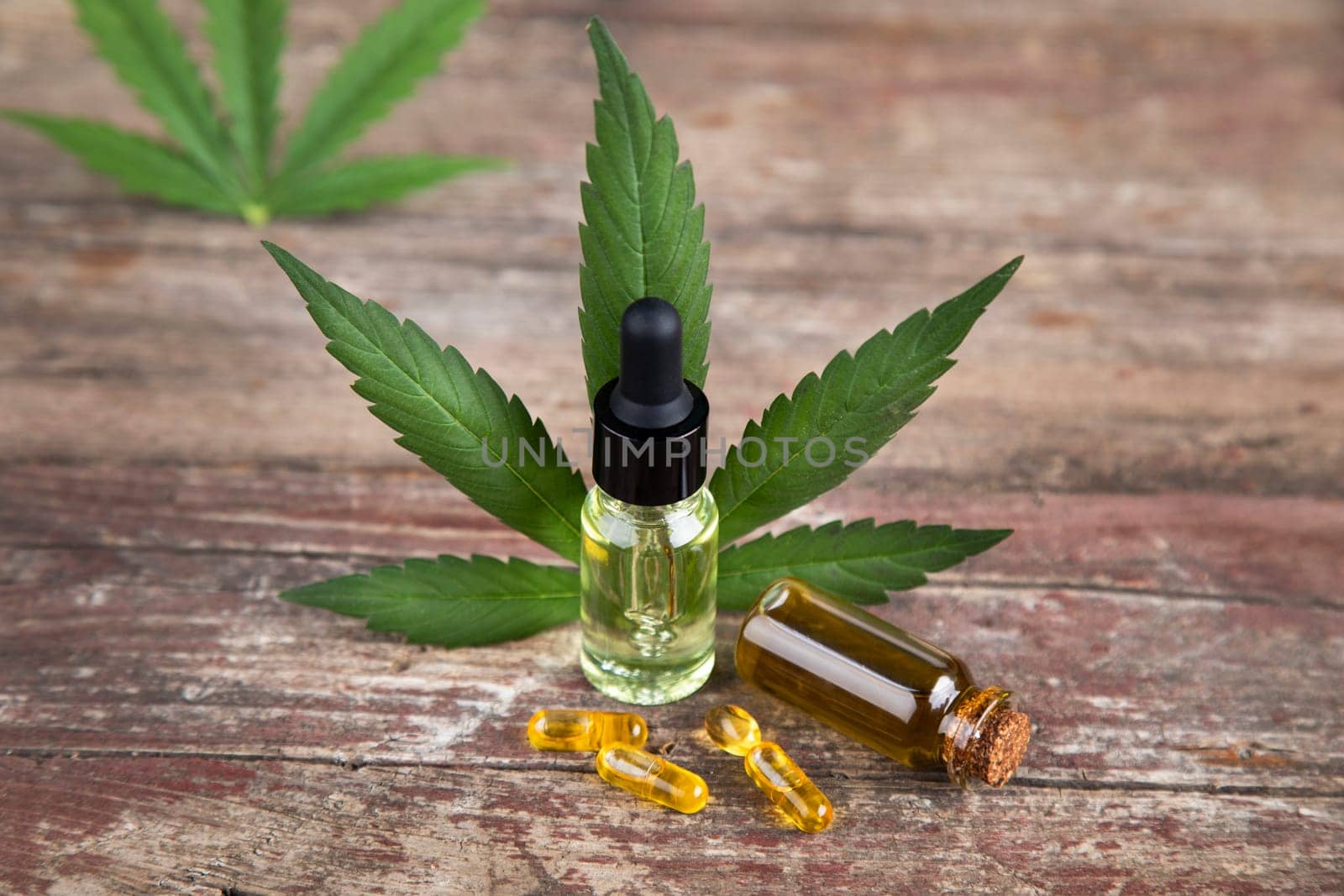 Bottles with hemp oil and cannabis leaves, marijuana