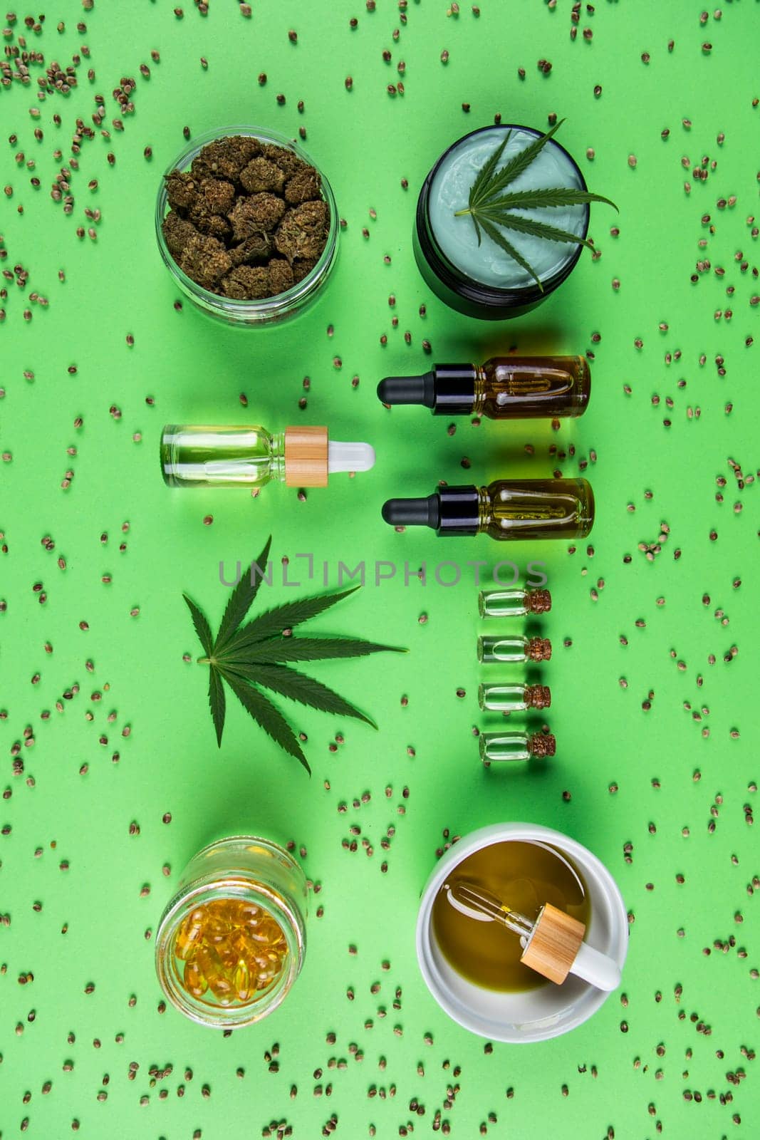 Composition with marijuana leaves, bottle of oil, cannabis on cbd