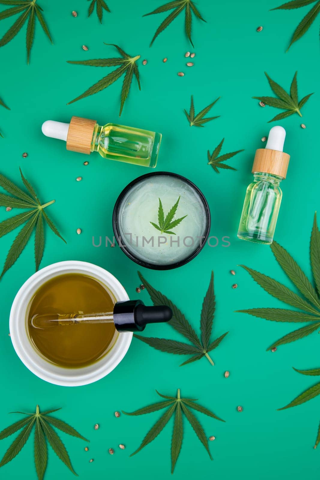 Flat lay composition with marijuana leaves, bottle of oil, marijuana and cannabis on cbd