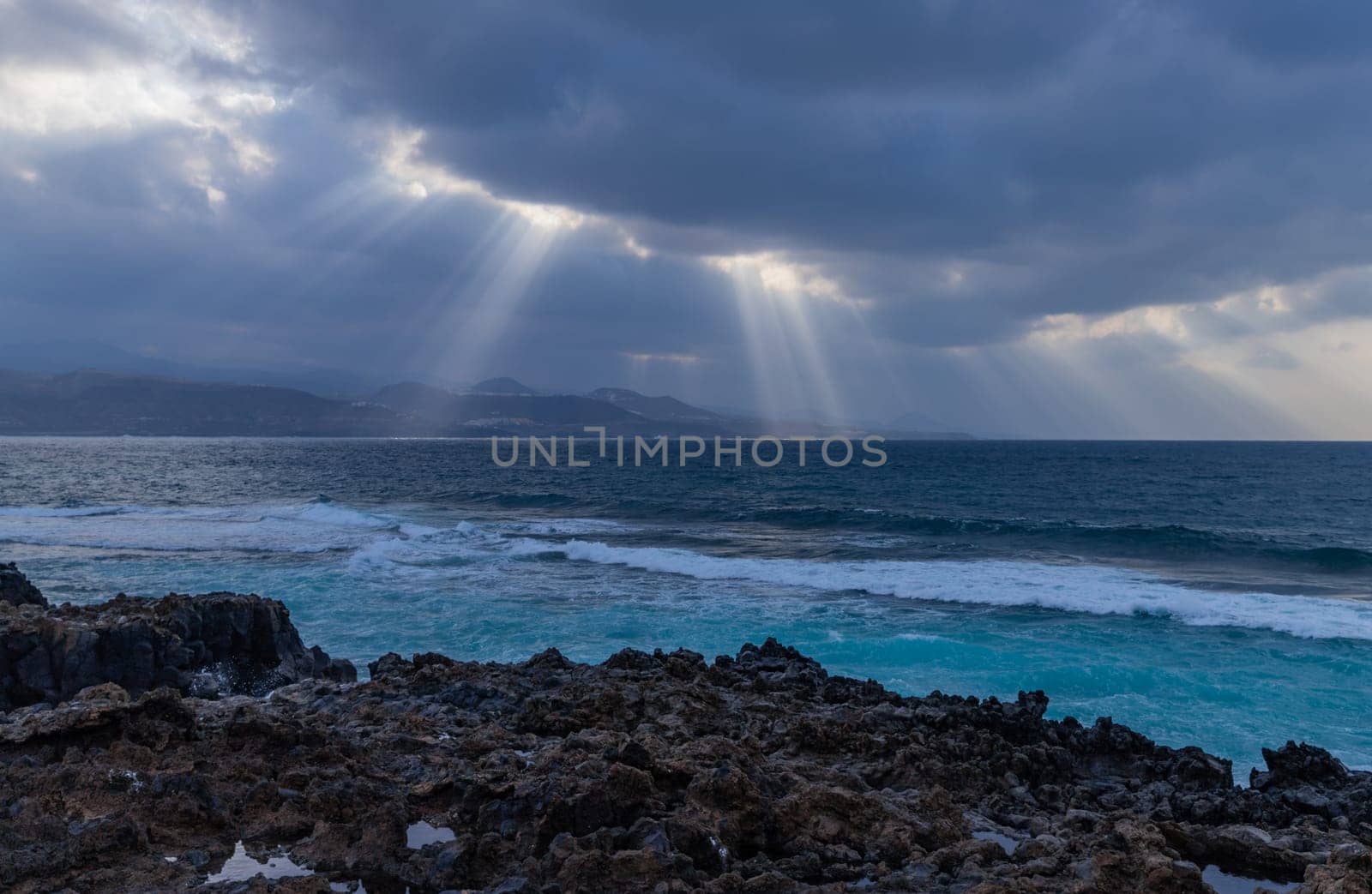 Beautiful sunrays on the Atlantic coast in Las Palmas de Gran Canaria, view from Las Canteras beach
