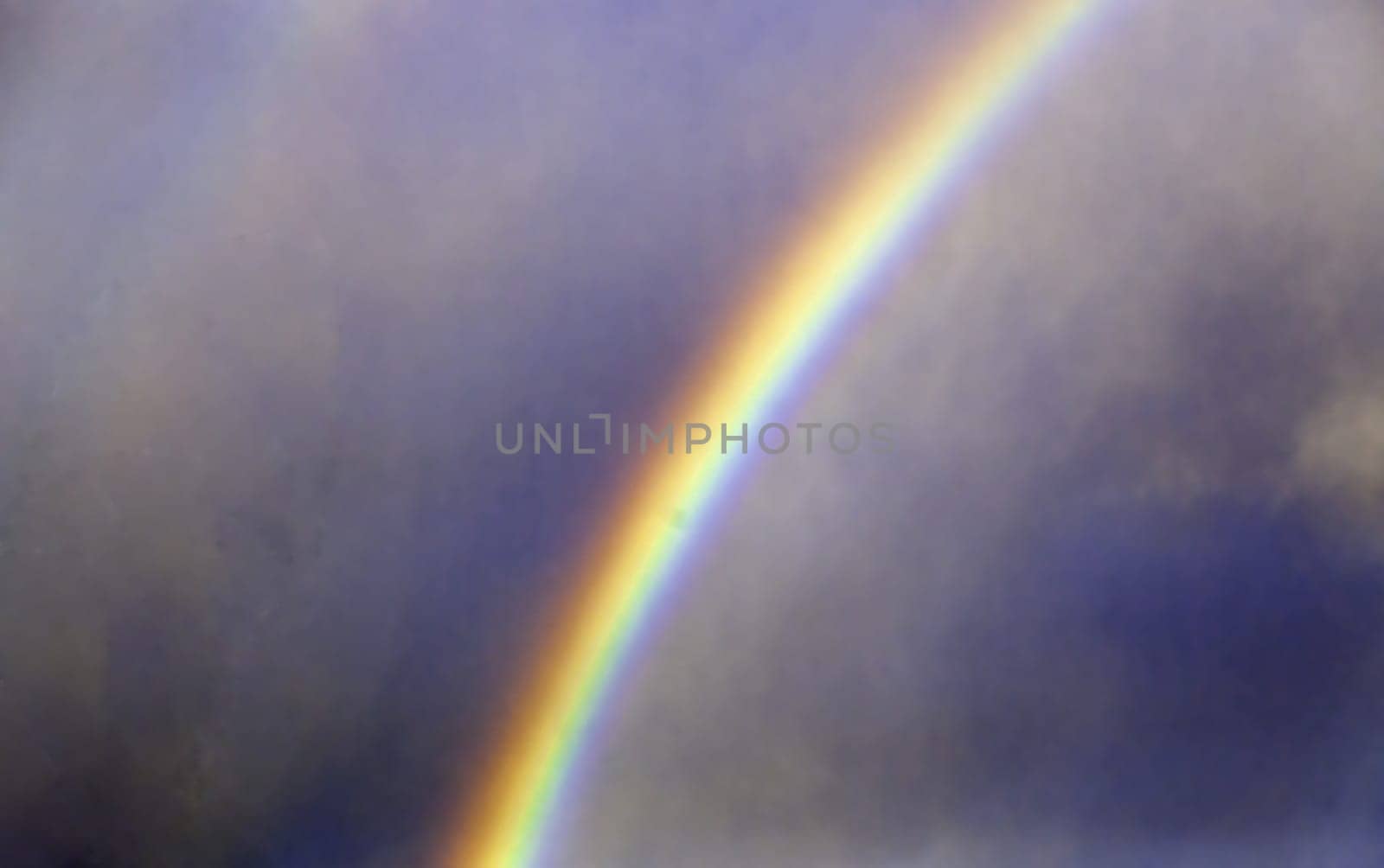 Rainbow detail on a rainy and stormy day in the city