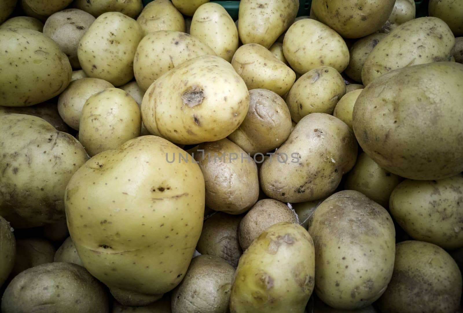 Detail of raw potatoes in a market, healthy food, vegan