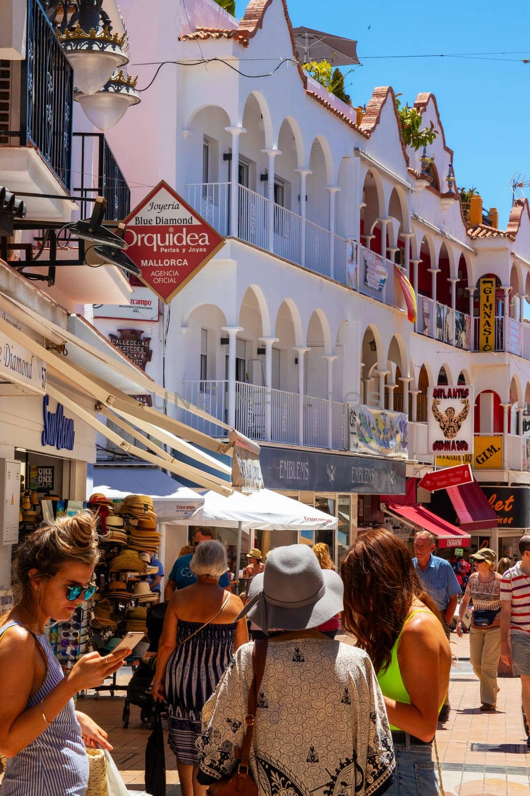 TORREMOLINOS, SPAIN - May 21, 2019. Calle San Miguel is the most popular shopping street in Torremolinos. This street offers many shops, cafes and ice bars and the tourists love to stroll through it.