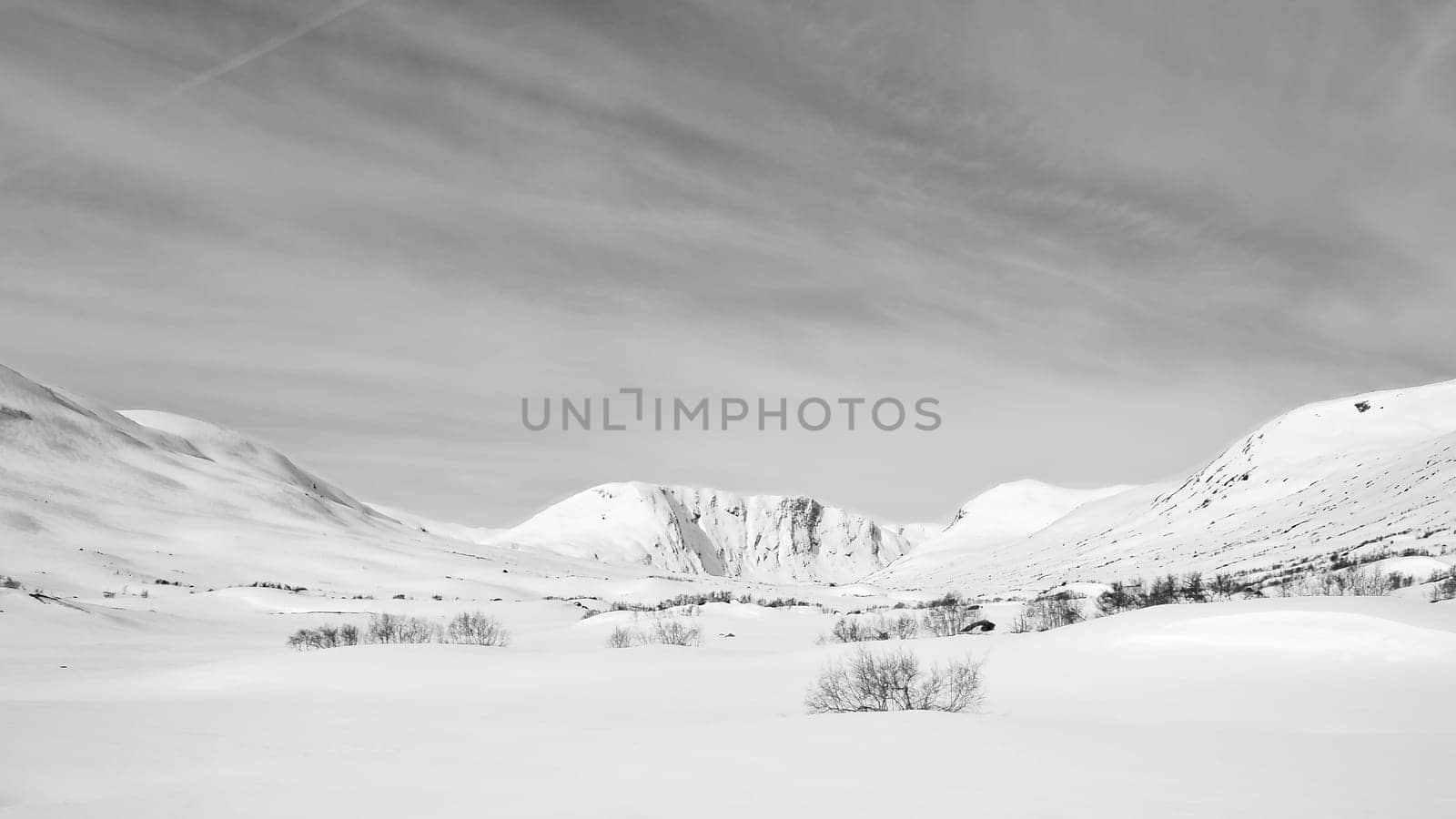 Norwegian high mountains in the snow. Mountains covered in snow. Taken in black and white. Scandinavian landscape in the far north