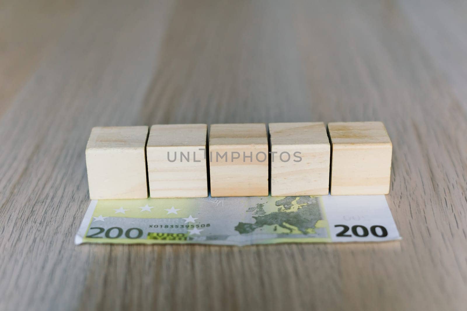 Wooden cubes blocks, money 200 Euro banknotes. Management big salary career conception
