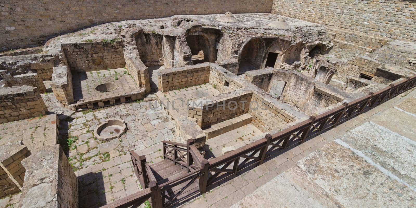 A view of the ruins of the bathhouse within the Shirvanshahs Palace in Baku, Azerbaijan. The stone structure shows the remnants of a once grand and functional building