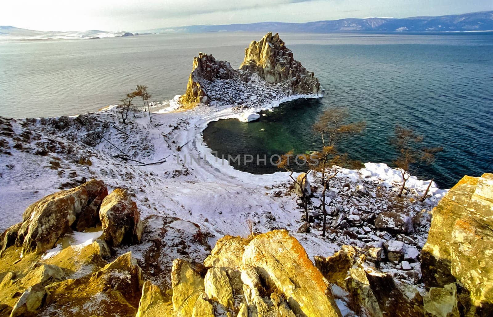 Winter on the Baikal, ice and snow on the lake. The beauty of the nature of Baikal in winter.