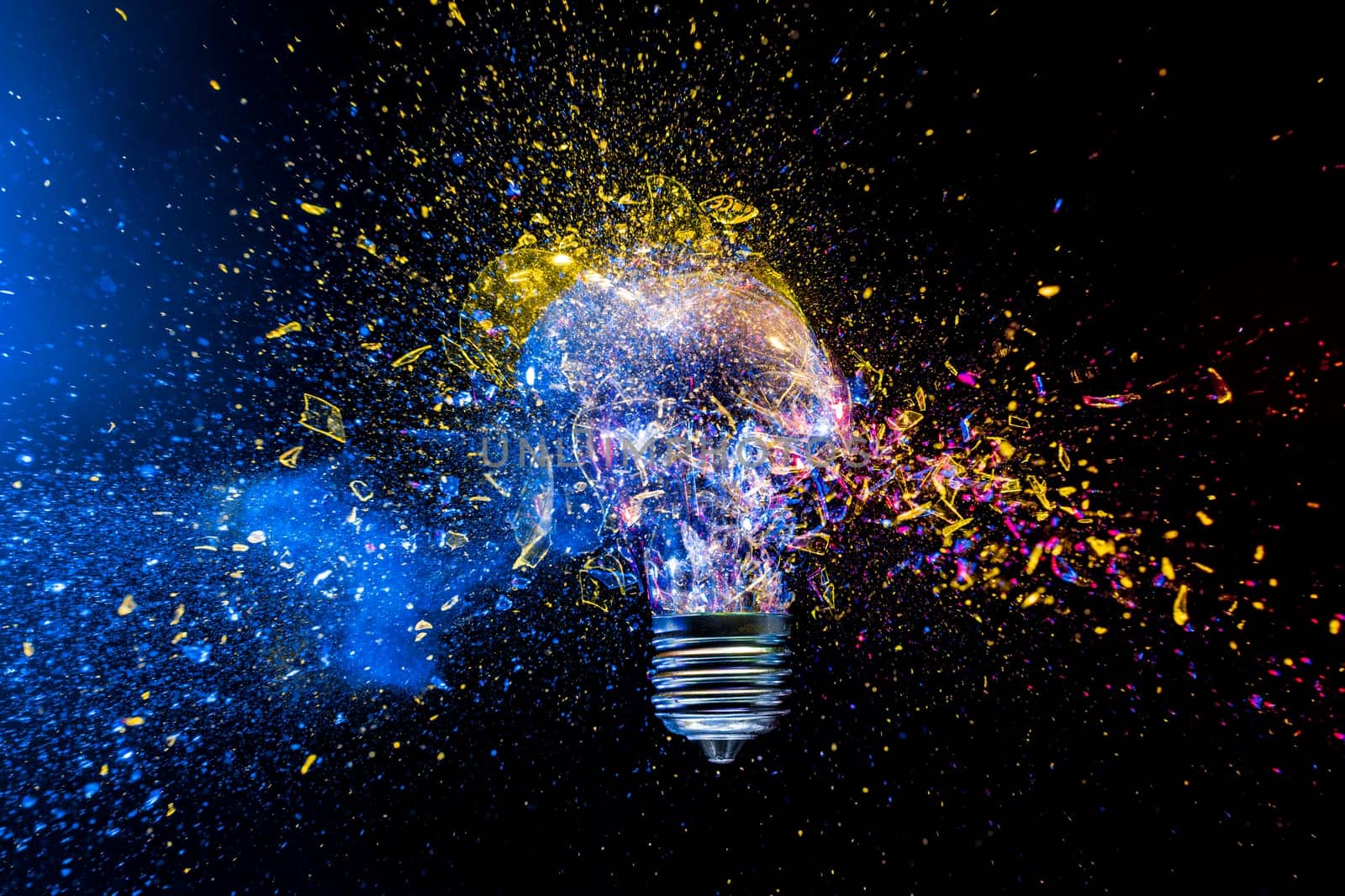 Light bulb exploding colorful powder,  innovation creative concept