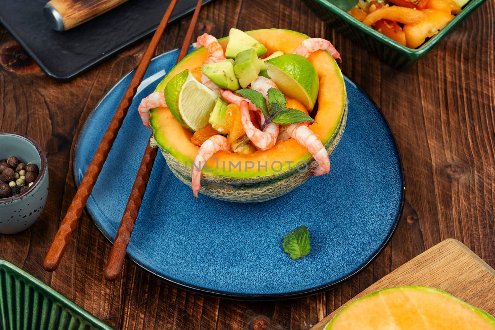 Asian salad of melon, shrimp and avocado. Summer light food.
