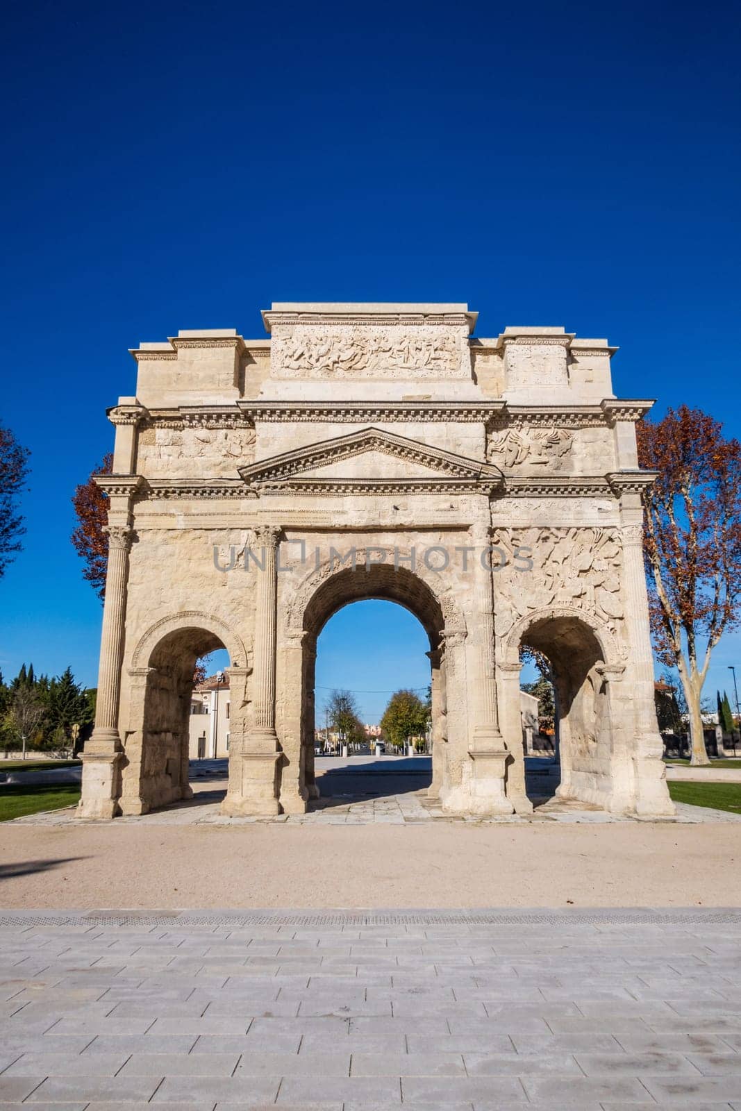 Famous Roman triumphal arch in Orange city, in the Vaucluse department in the Provence-Alpes-Côte d'Azur region. Vertical photography taken in France