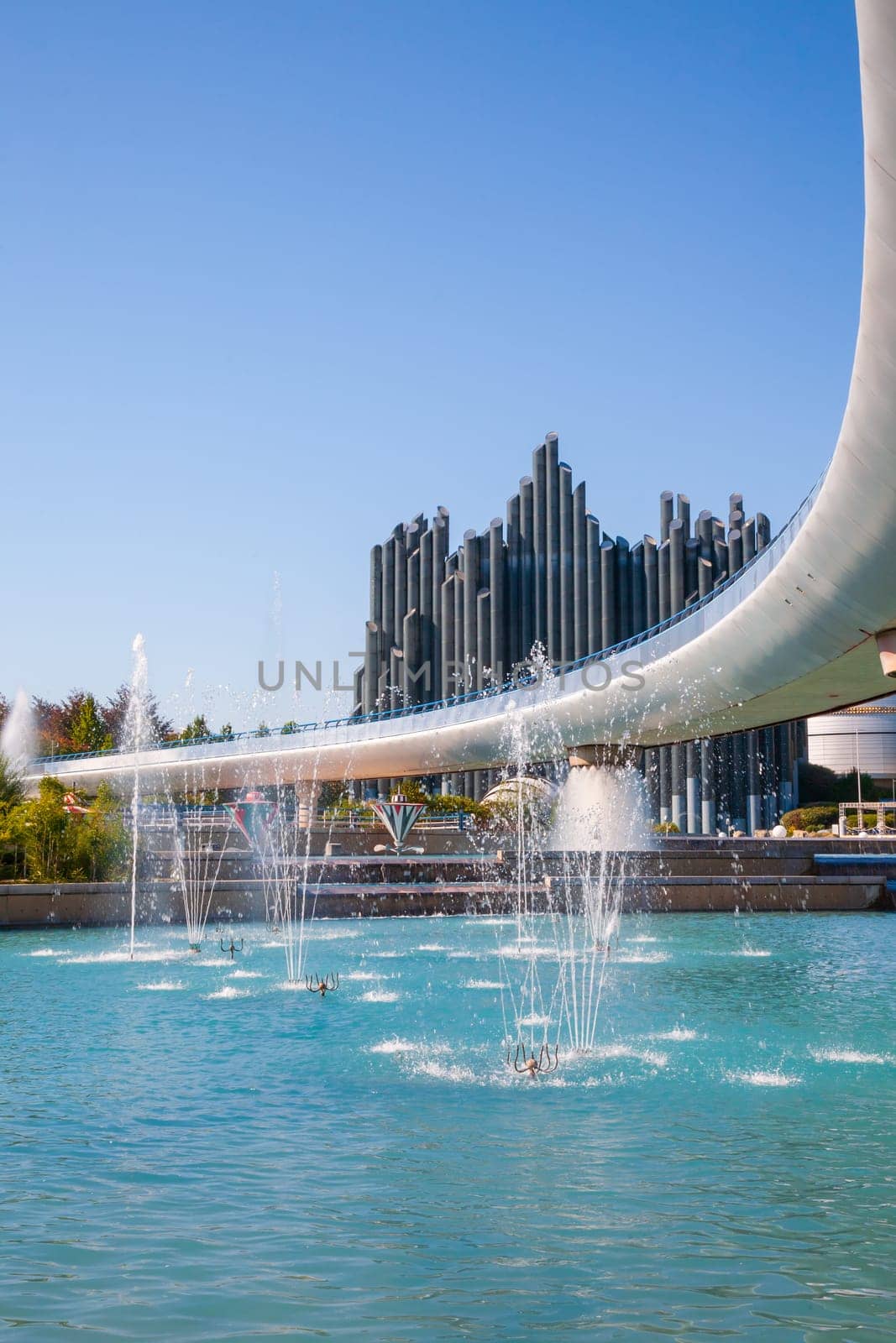 Poitiers, France - September 22, 2010: Water jets and Magic Carpet building that looks like an imaginary organ in Futuroscope, a science and technology theme park in Poitiers, France