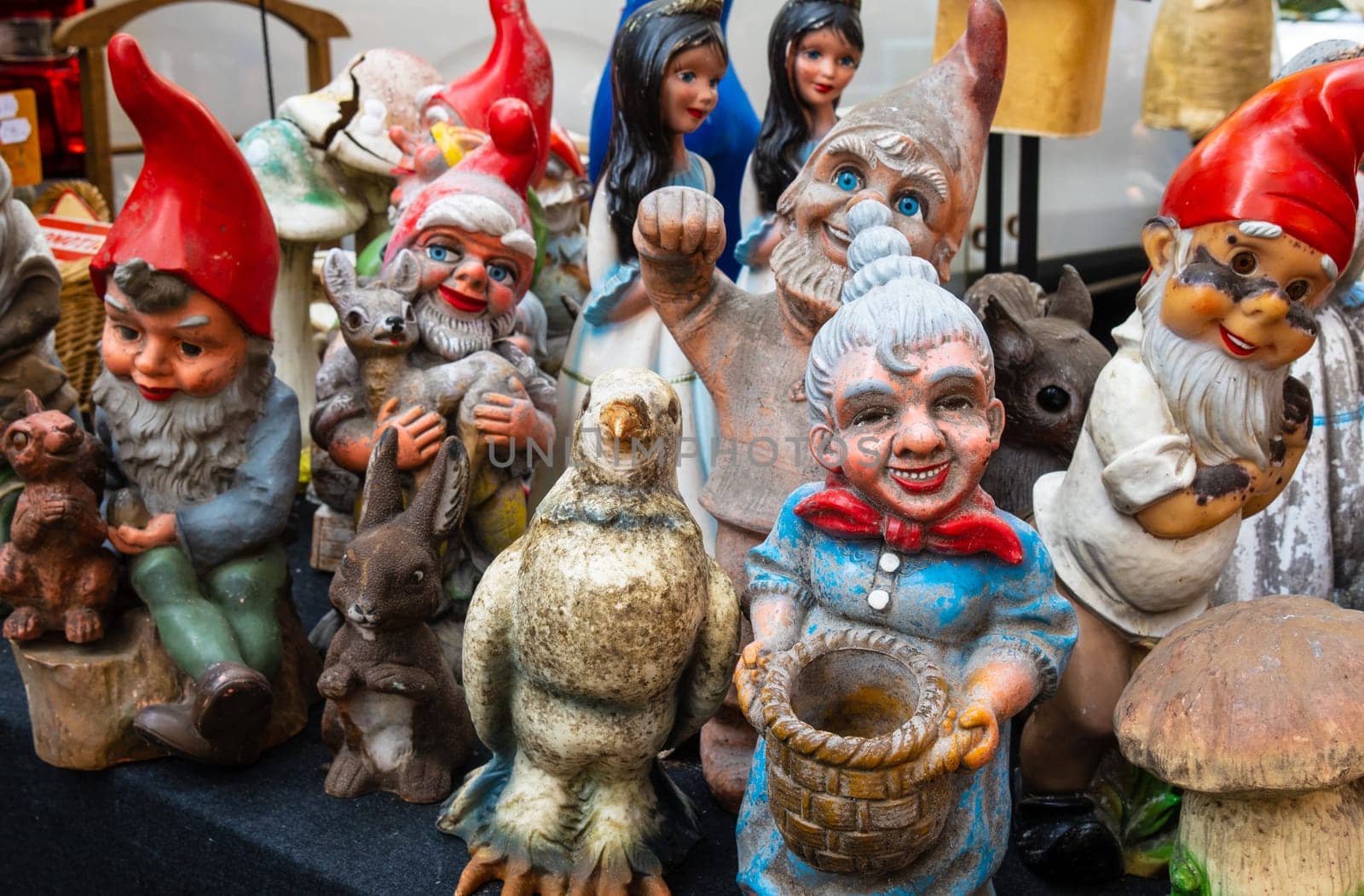 Lille, France - September 04 2022: Group of Second-hand garden gnomes and decoration figurines