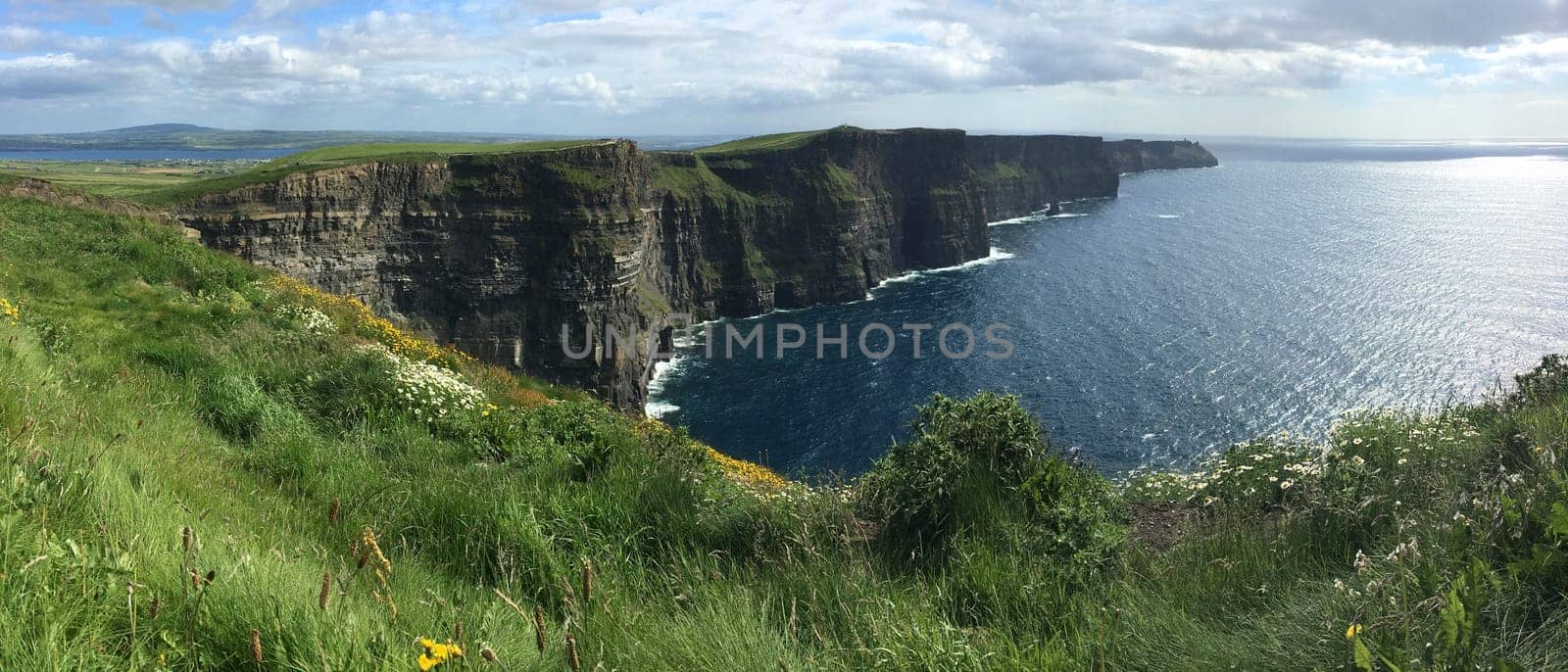 Panoramic view of the Cliffs of Moher - located at the southwestern edge of the Burren region in County Clare, Ireland. They rise 120m (390ft) above the Atlantic Ocean at Hag's Head and reach their maximum height of 214m (702ft) here just north of O'Brien's Tower.