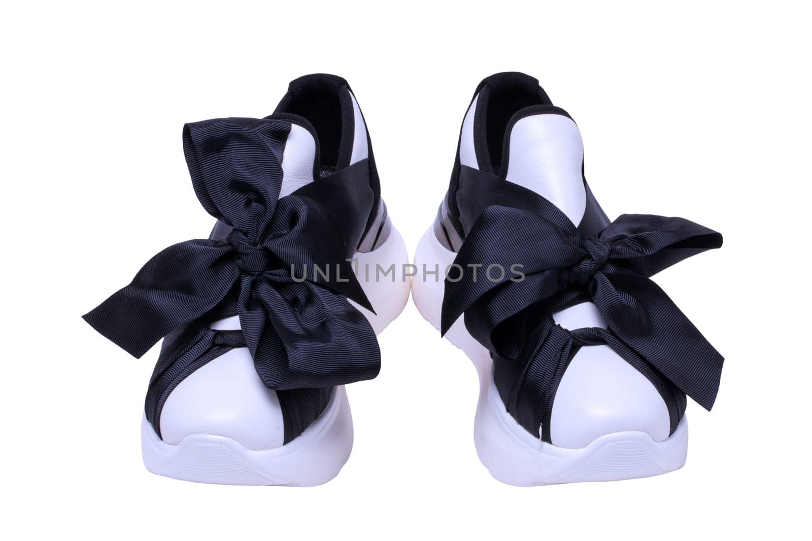 White sneaker isolated. Close-up of a pair black white elegant stylish female leather high-heeled sport shoes isolated. Clipping path. Womens shoe fashion. Modern design footwear for workout.