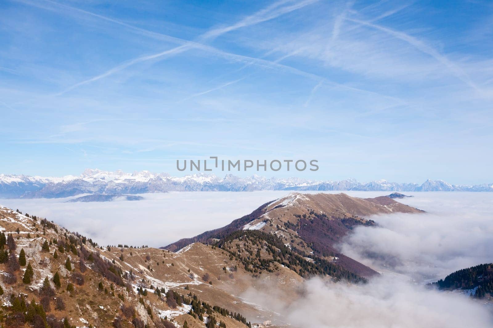 Mountain peaks emerging from the clouds. Italian alps landscape