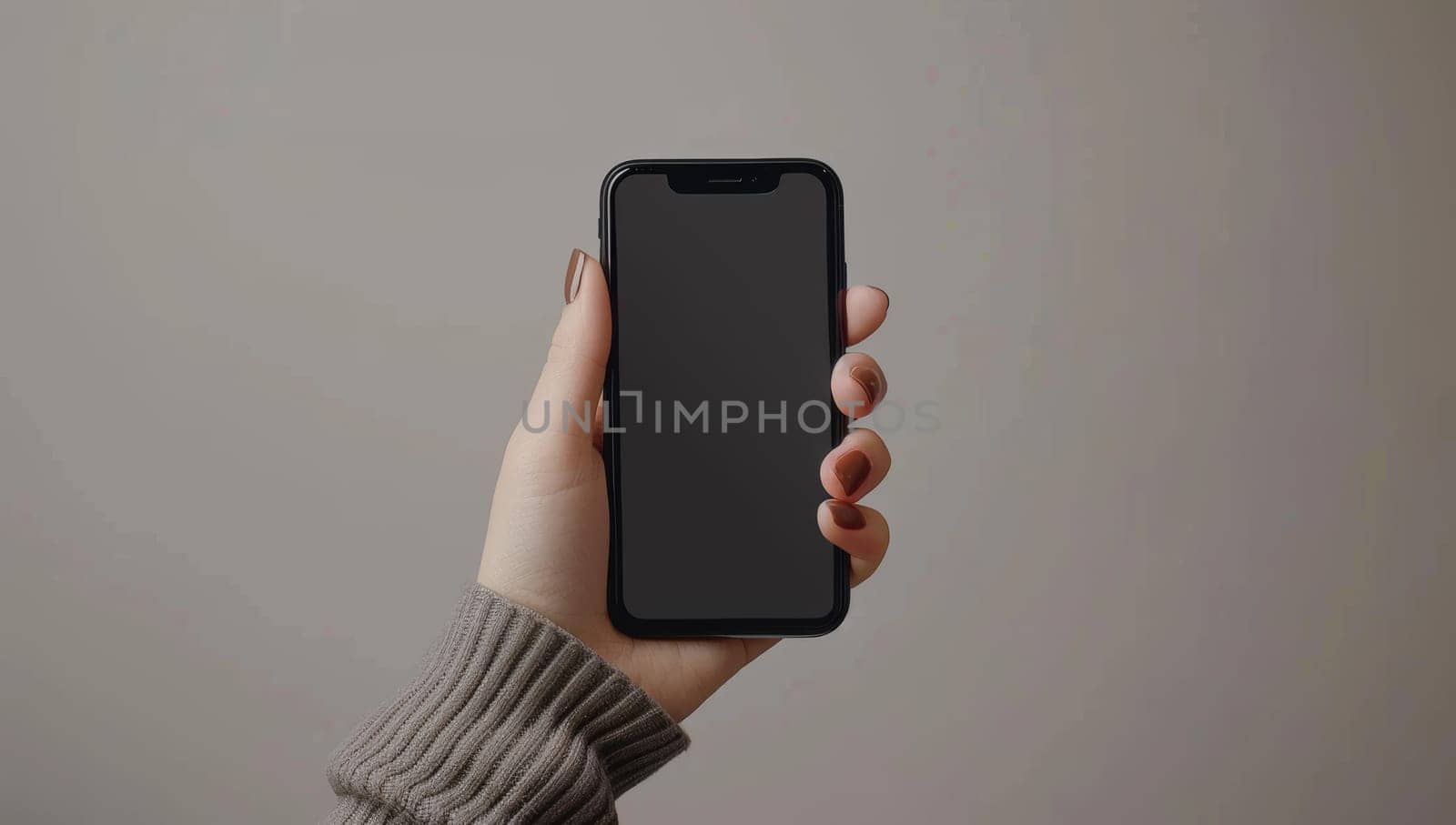 Woman's Hand Holding a Smartphone with a Blank Screen