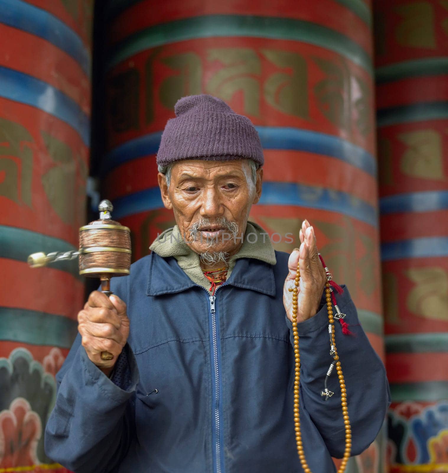 A Bhutanese man with prayer wheels in Paro Dzong in the Kingdom of Bhutan.