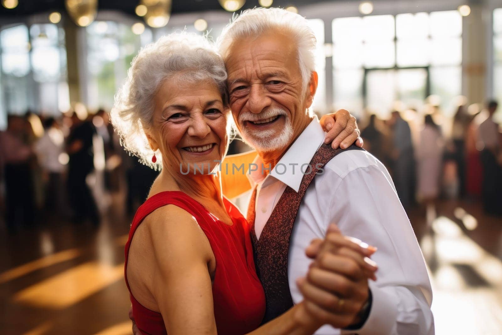 Happy senior couple dancing at a party.  Joyful elderly man and woman enjoying retirement life, celebrating anniversary, or attending a wedding reception.