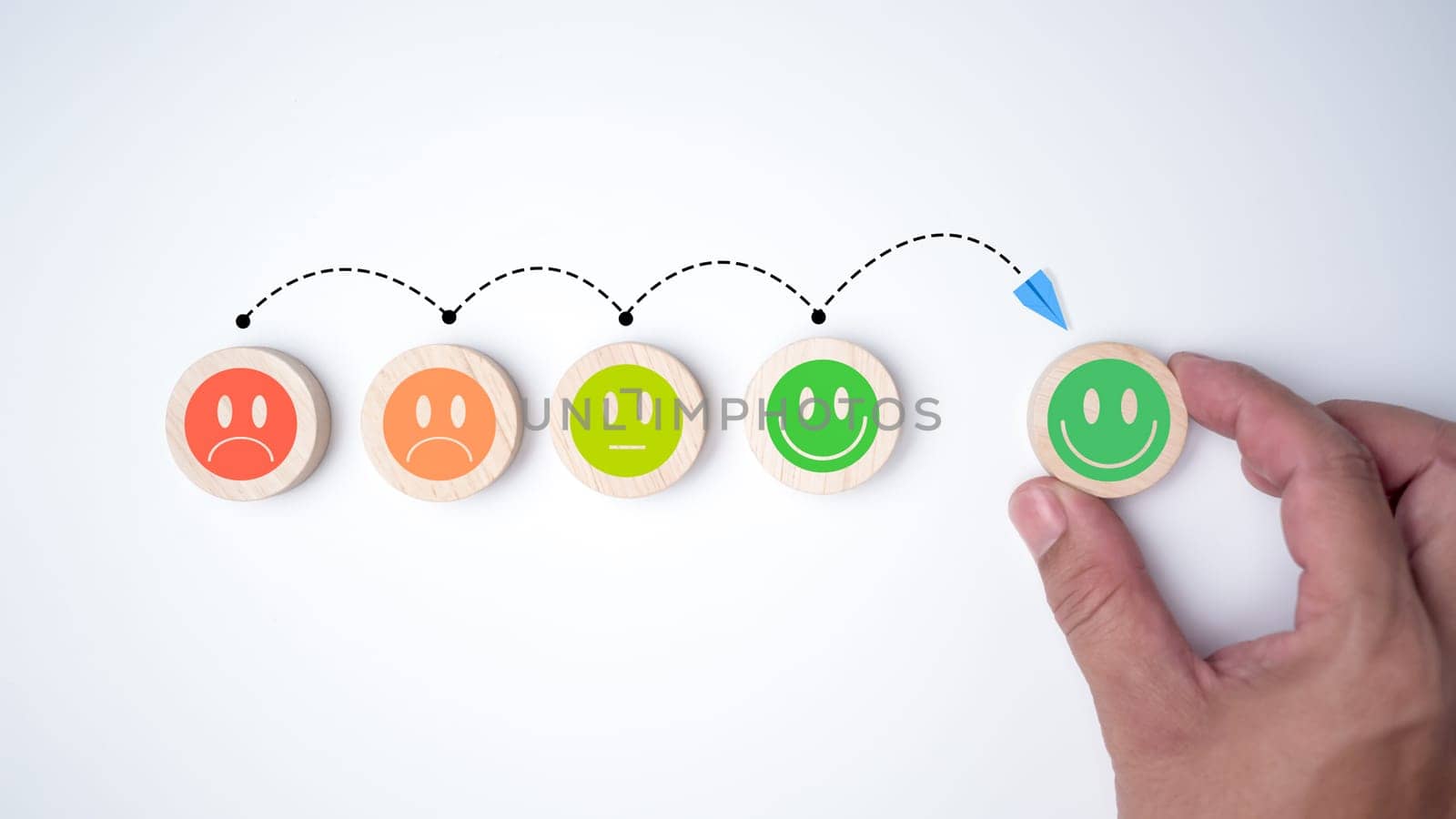 Customer service concept, Global best business scoring experience satisfaction survey concept, Human hand selects a smiley face on a wooden block, Mental health positive thinking.