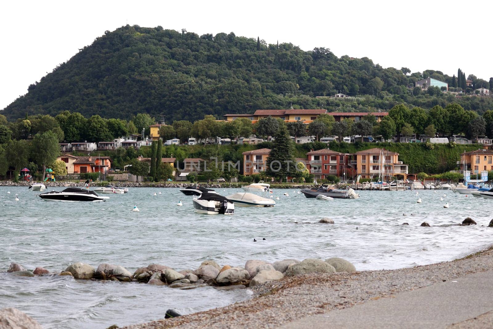 Boats in the water,a storm is gathering in front of the small picturesque bay of Manerba del Garada on Lake Garda  Travel Photography - Lake Garda / Lago di Garda / Italy /Italy / Italia