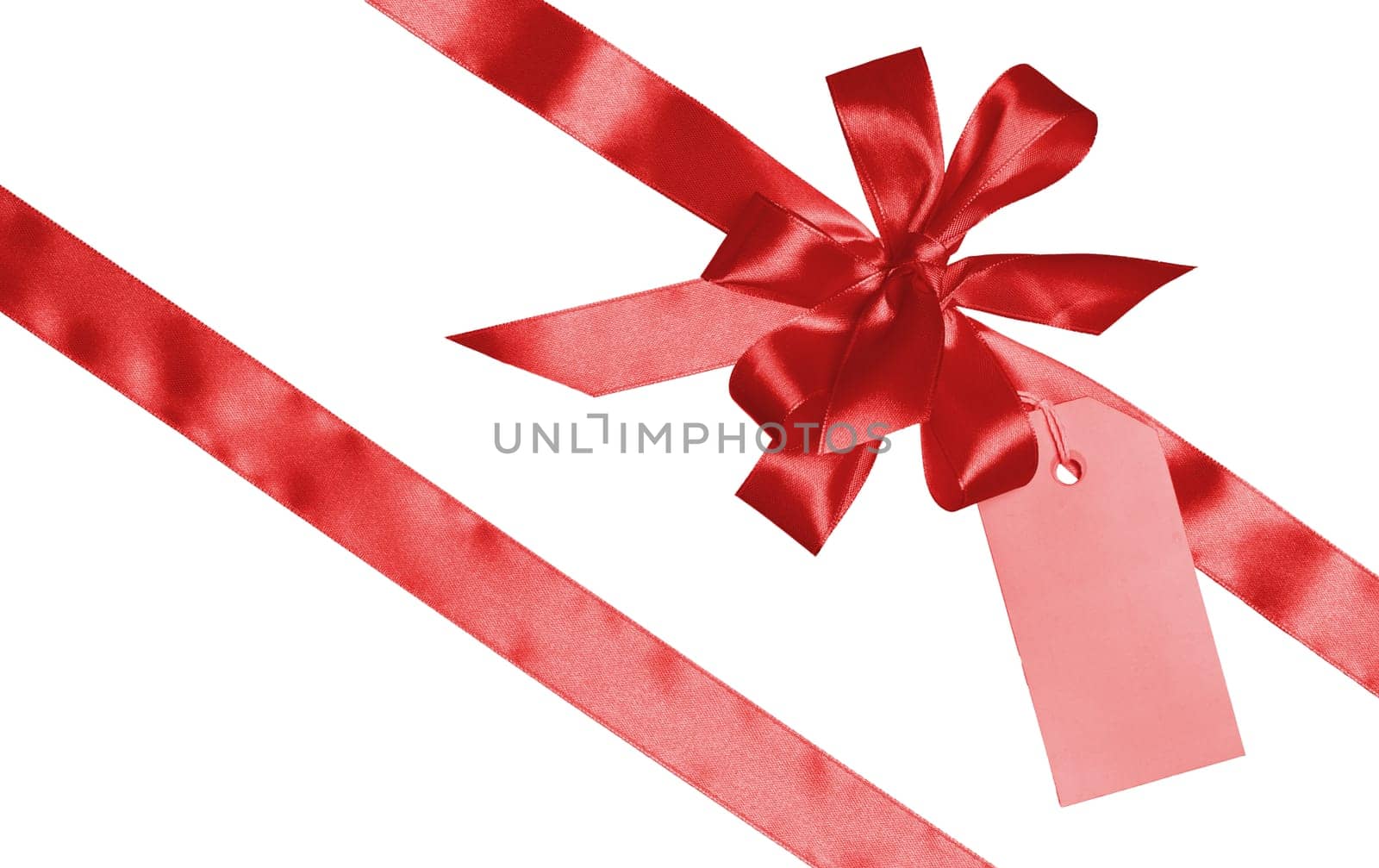 Red silk ribbon and bow, yellow paper tag for congratulations. Isolated background