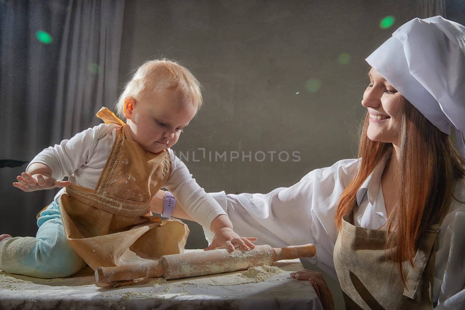 A mother and daughter joyfully engage in a flour-filled moment, creating memories in a cozy kitchen setting.