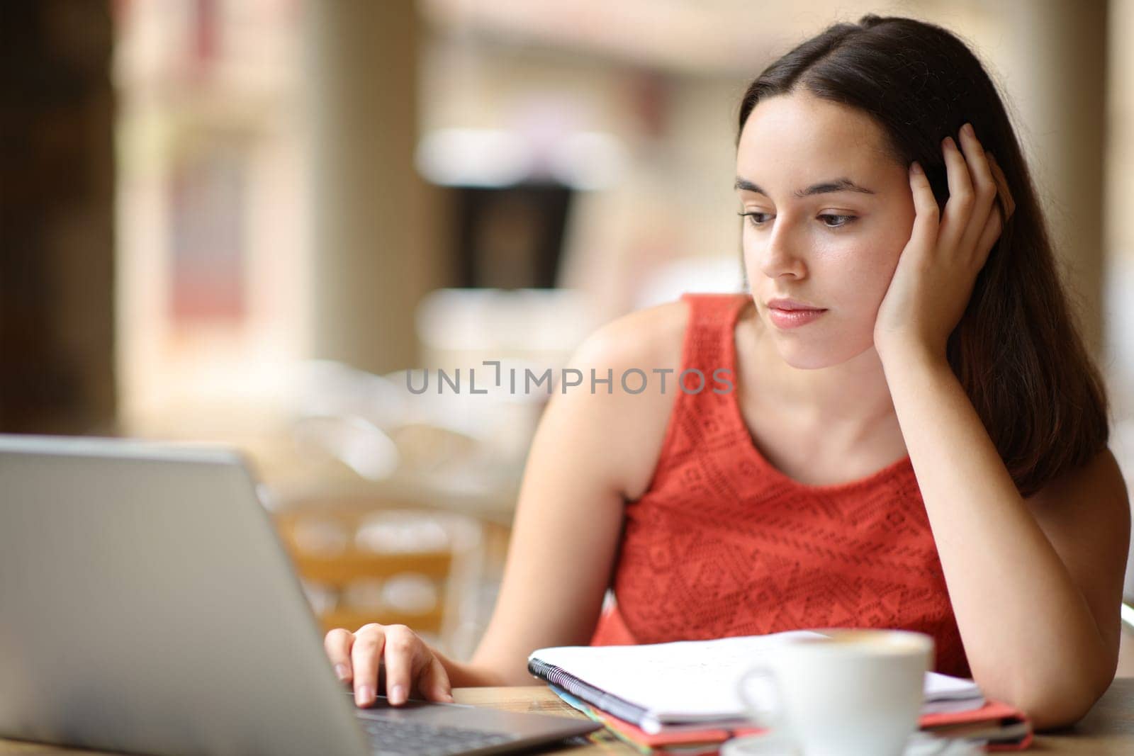 Student e-learning using computer sitting in a coffee shop