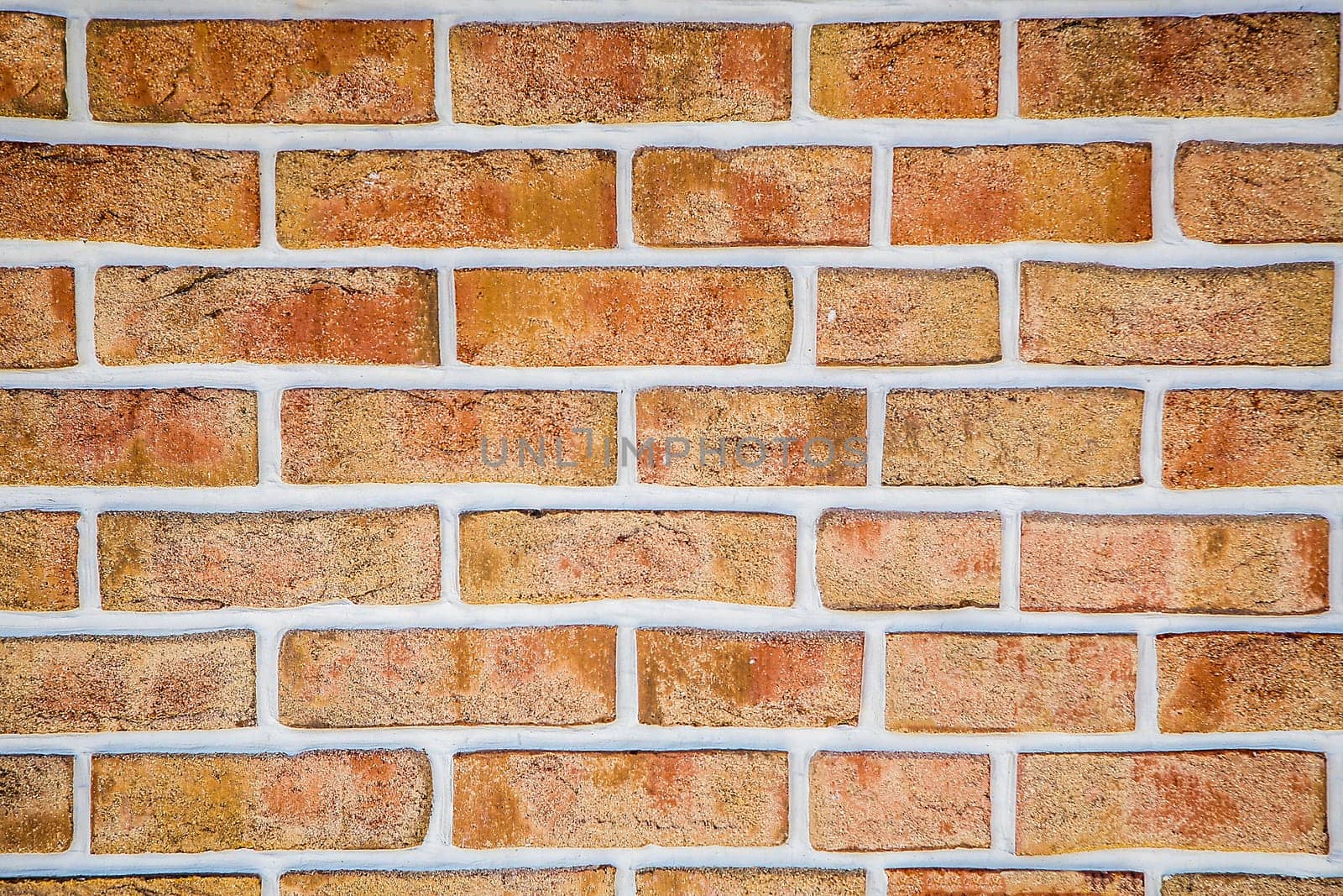 A weathered red brick wall with visible grout lines arranged horizontally, background image