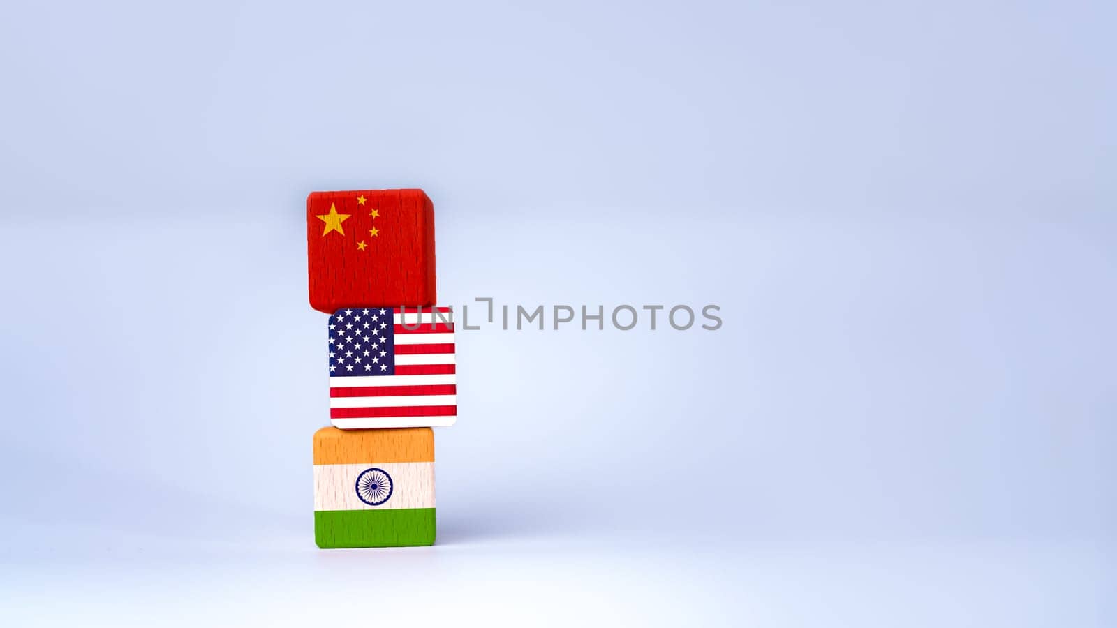 Screen printed USA flag and China flag on wooden cube, showing trade competition and tariff barriers, trade war between USA and China, global trade competition.