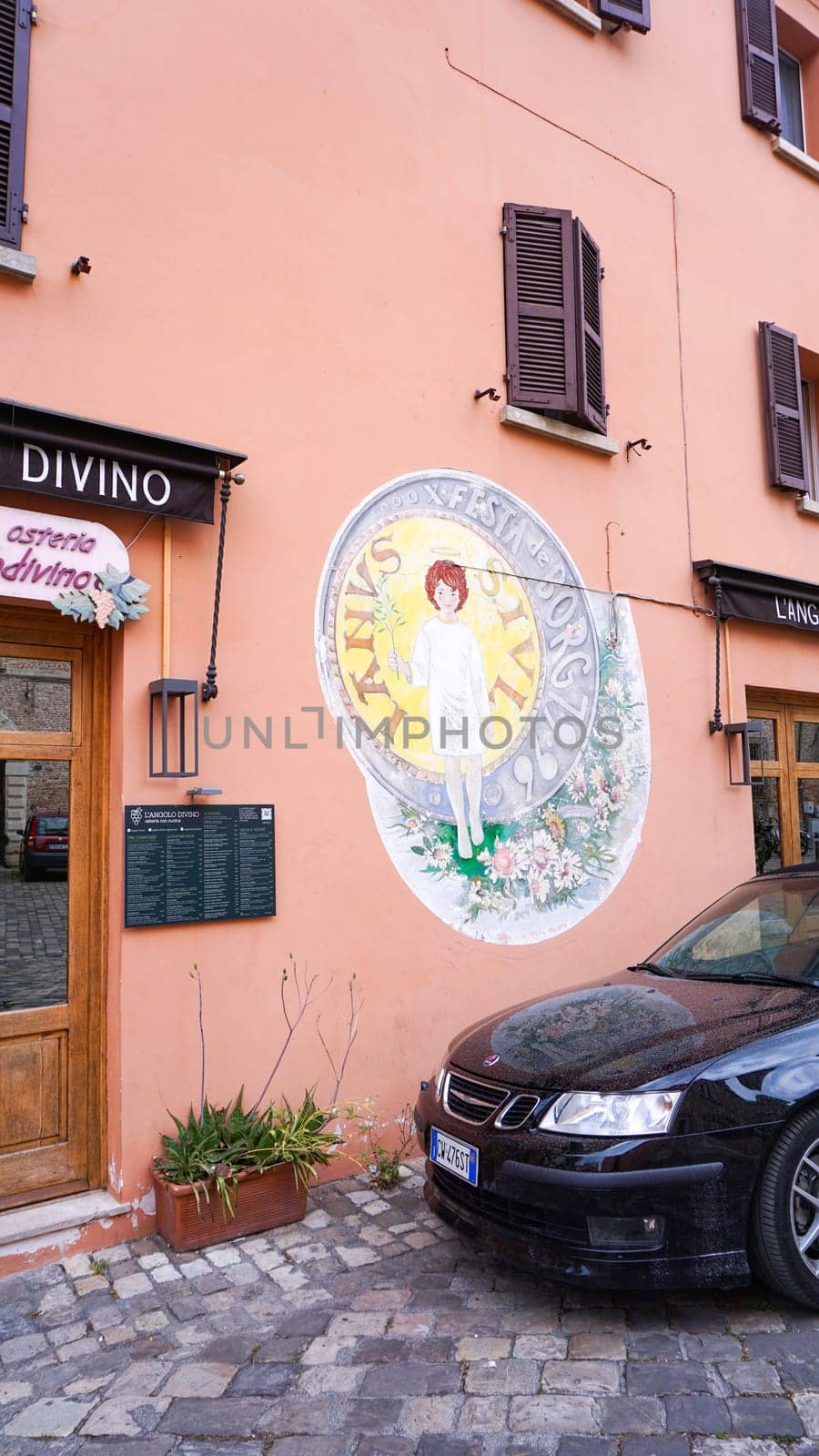 Rimini, Italy - June 25, 2024: Mural on wall at Borgo San Giuliano typical street with low and colorful houses at Rimini, Italy