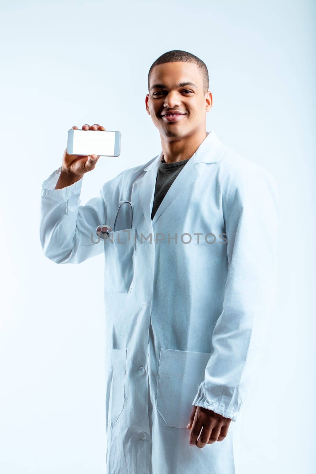 Military doctor with a confident smile, wearing a white lab coat and holding a smartphone. He suggests using medical mobile apps, emphasizing the importance of technology in healthcare