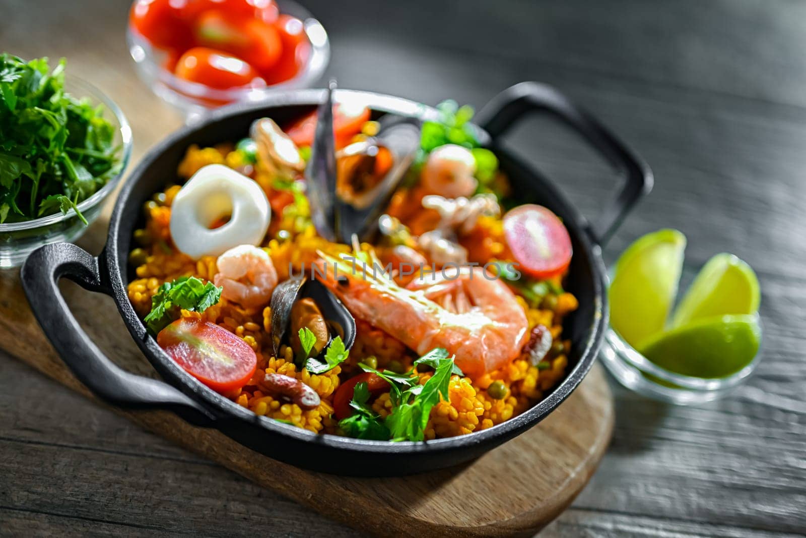 Seafood paella served in a cast iron pan.
