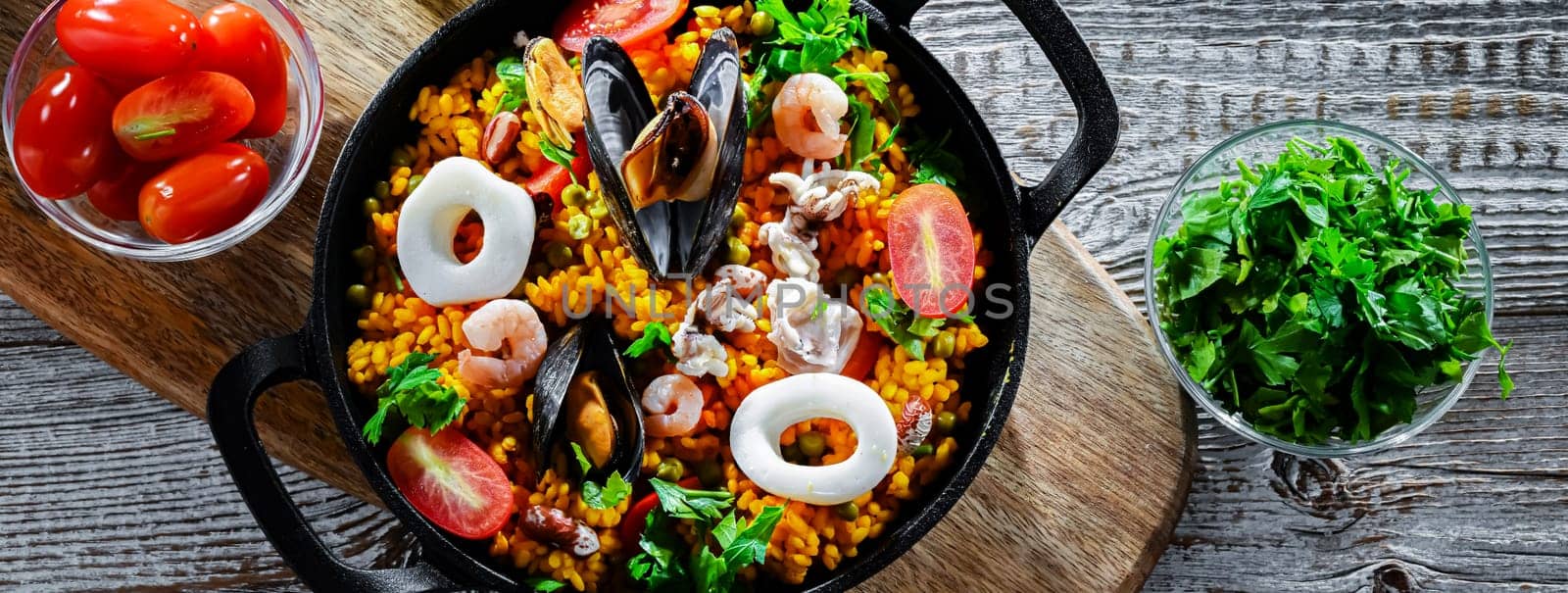 Seafood paella served in a cast iron pan.