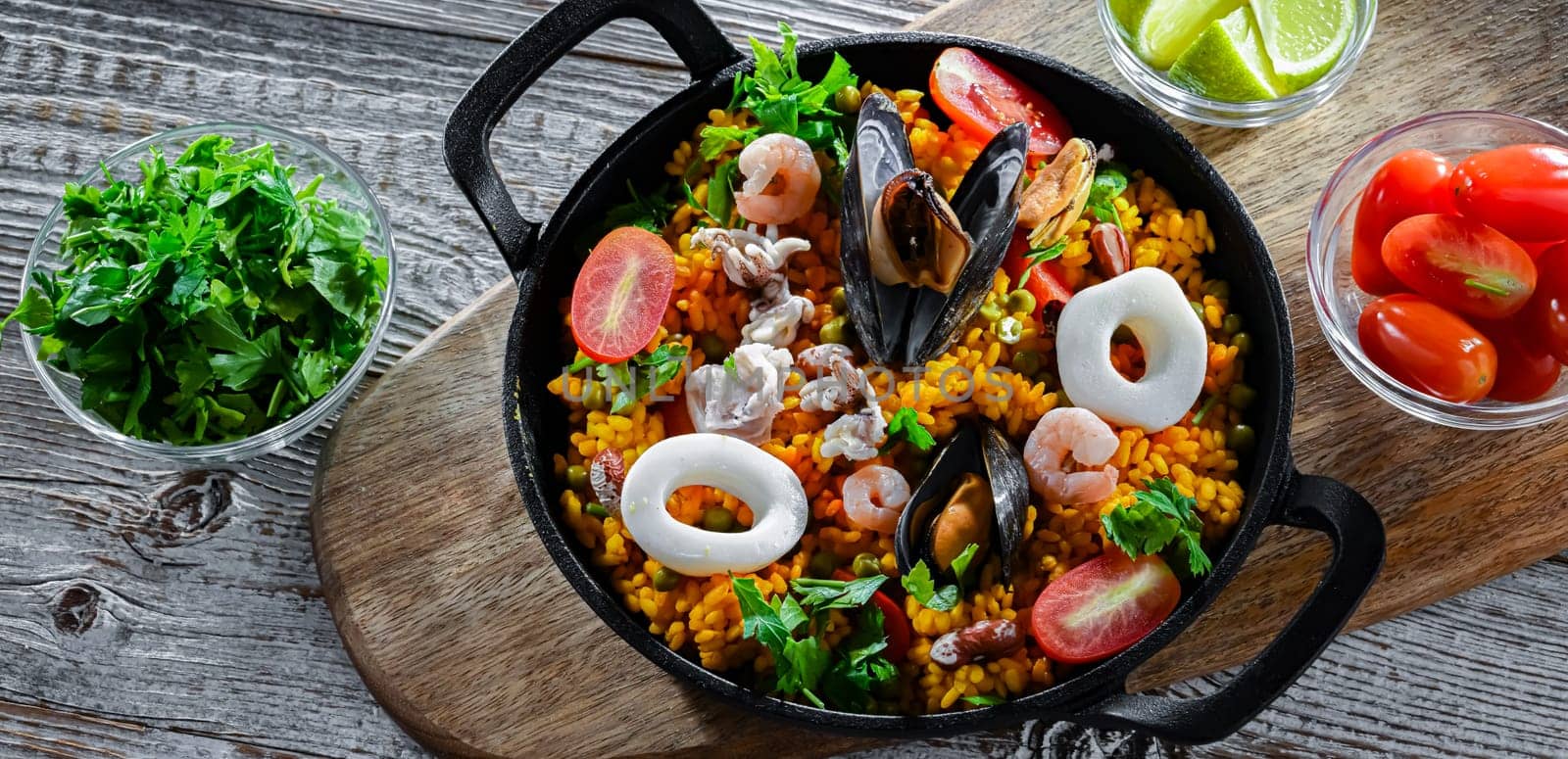 Seafood paella served in a cast iron pan.